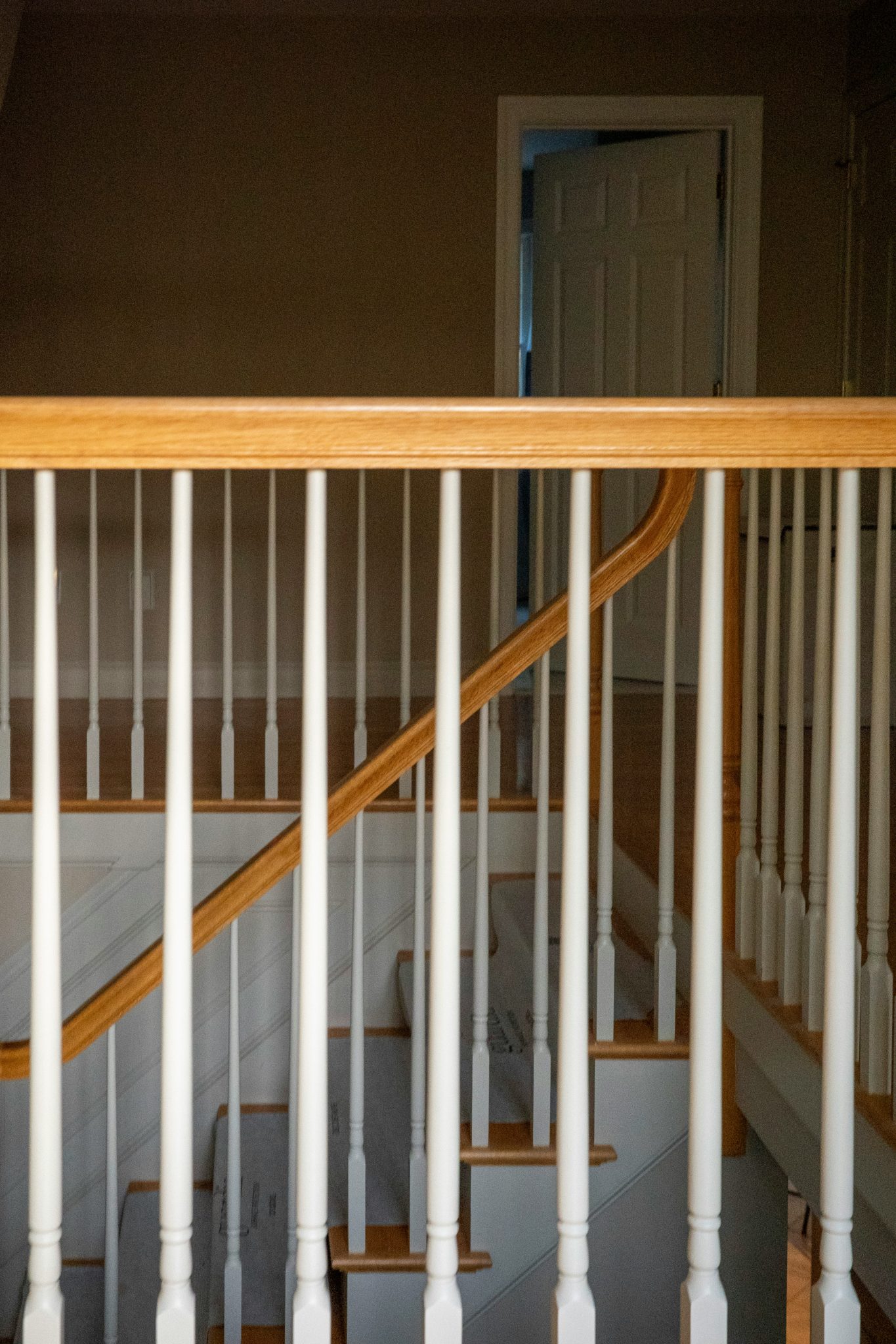 Wooden staircase with white banisters and railing