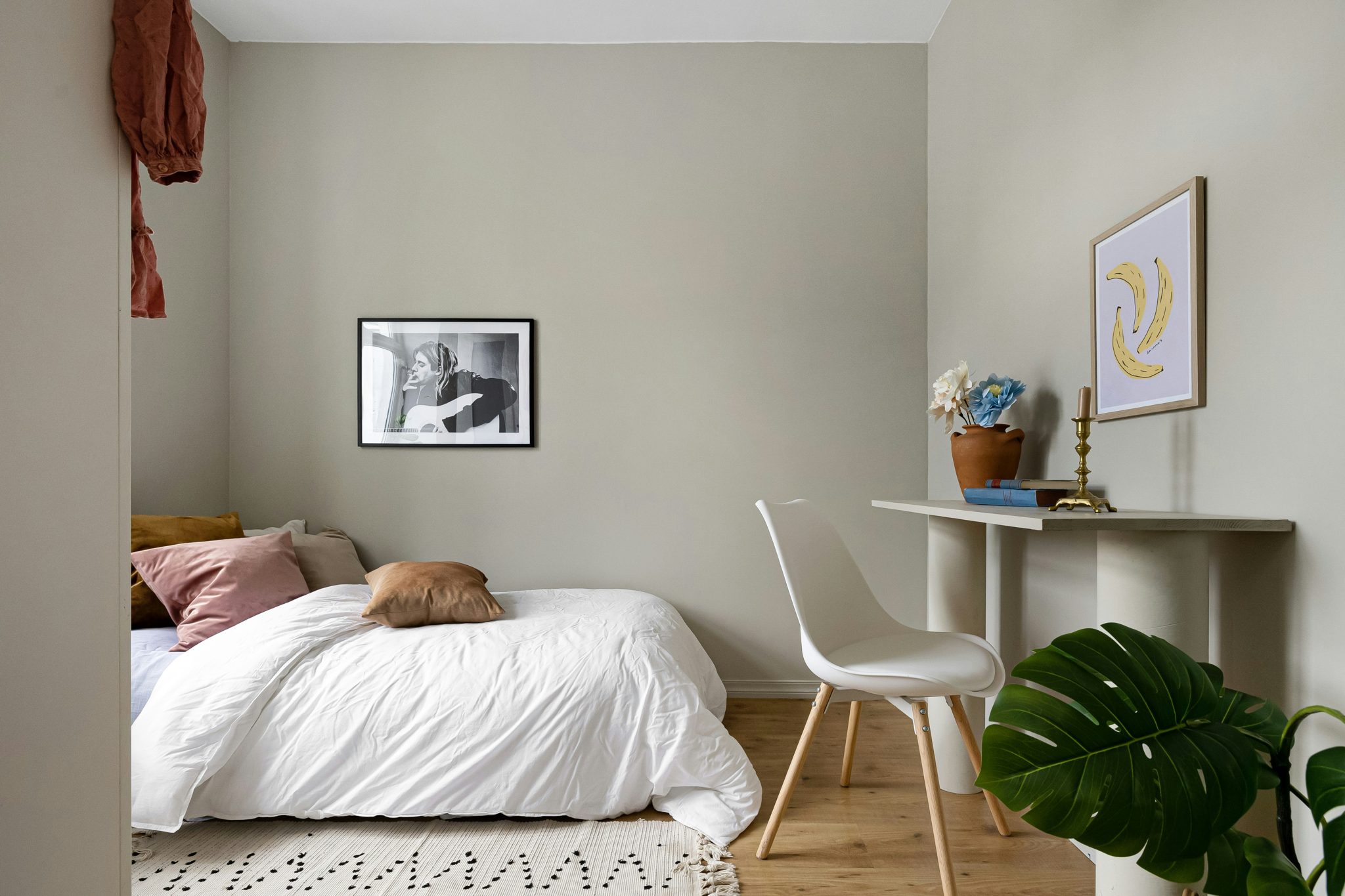 A bedroom with a bed and a desk