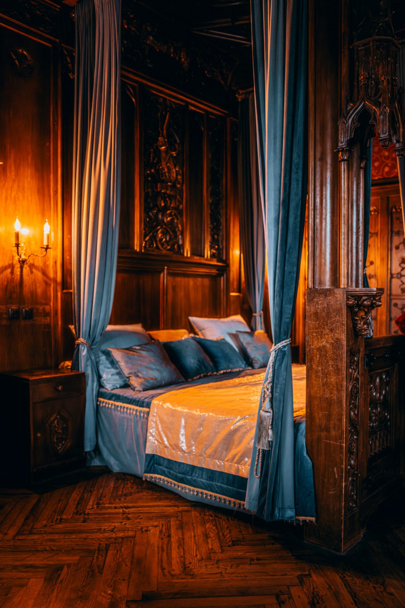 A bedroom with a canopy bed and wooden floors