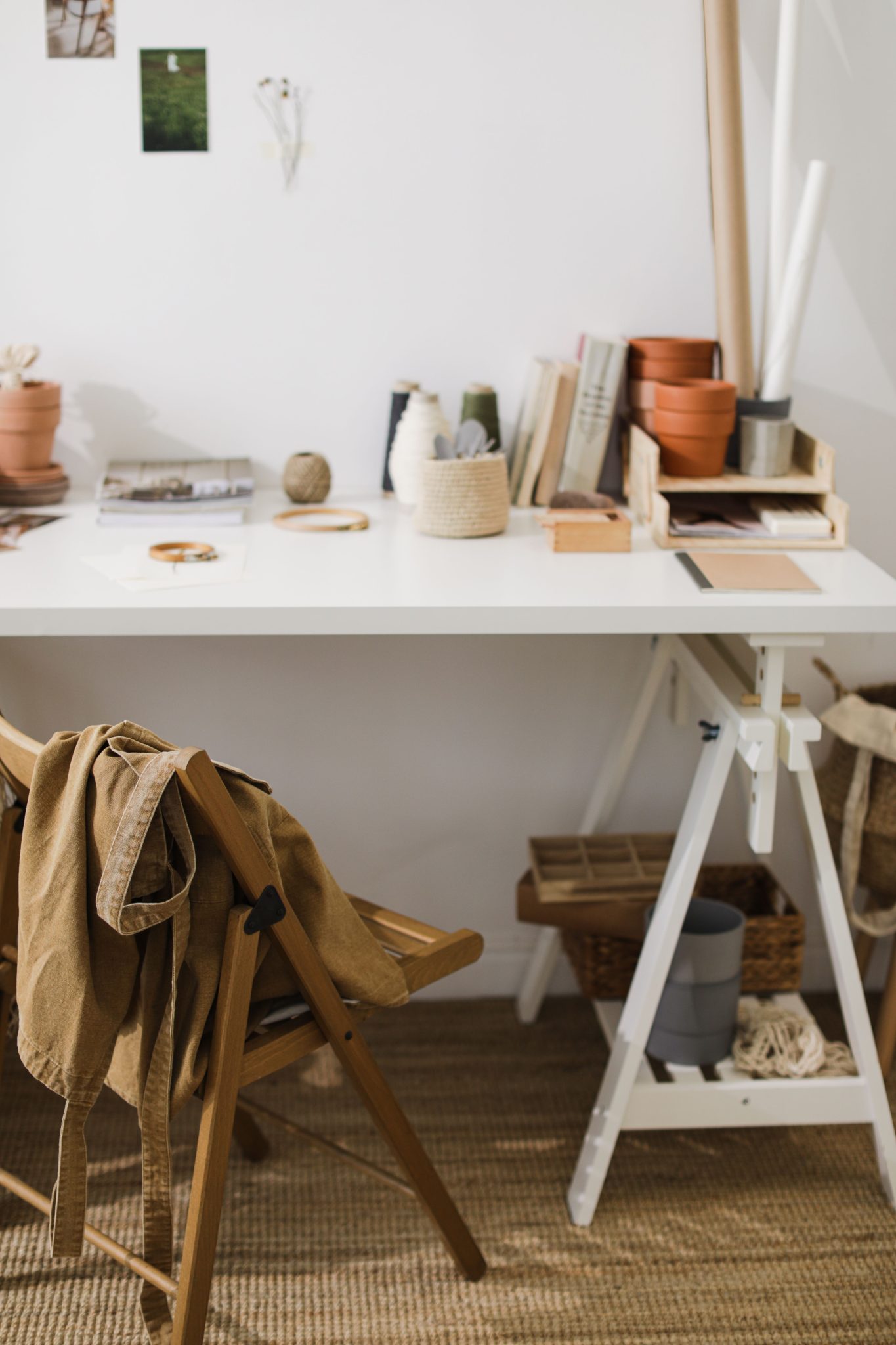 A serene and stylish workspace featuring plants and decor, perfect for creative tasks.