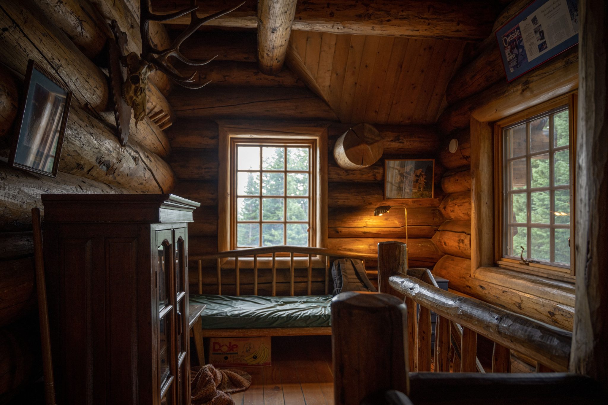 A warm and inviting rustic bedroom interior in a timber log cabin in Vail, Colorado.