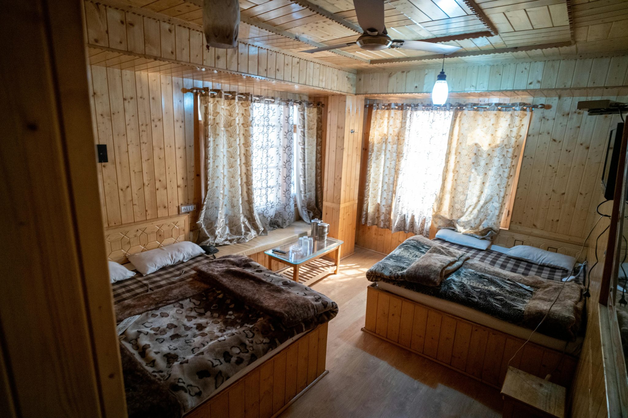 A warm and inviting wooden bedroom interior with cozy lighting in Srinagar.