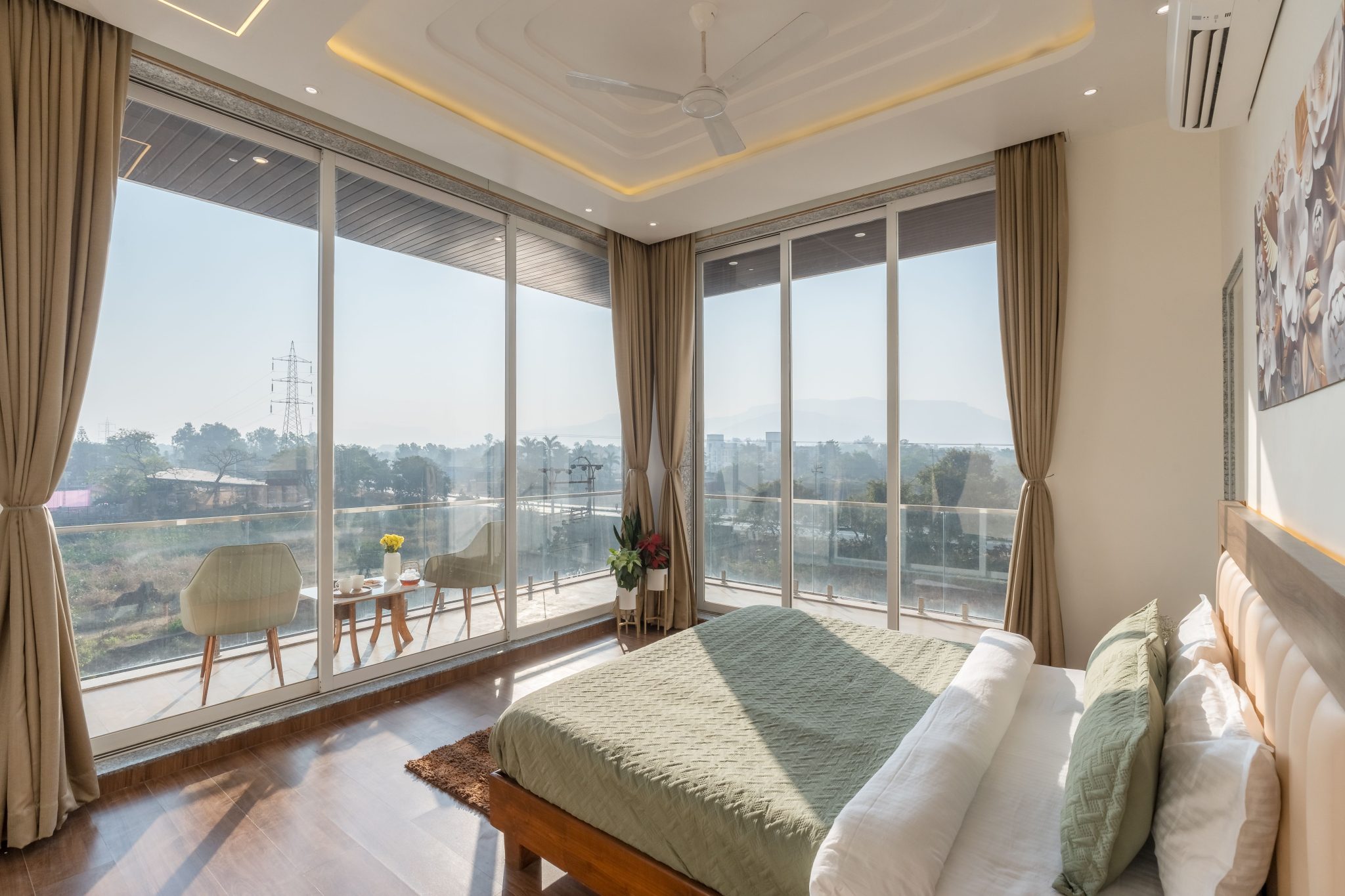 Bright modern bedroom featuring a scenic balcony view, perfect for relaxation.