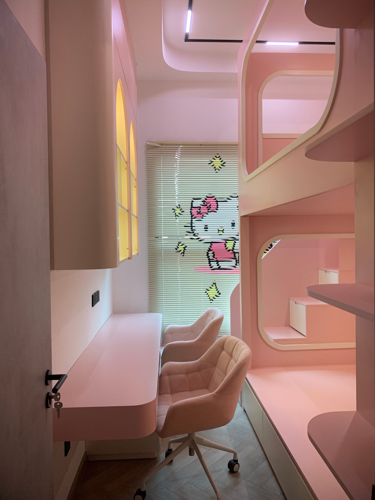 Contemporary pink workspace featuring stylish furniture and creative decor, ideal for youth.