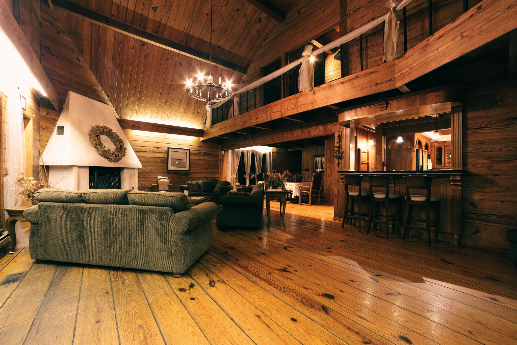 Cozy rustic living room with wooden decor and chandelier lighting, ideal for interior inspiration.