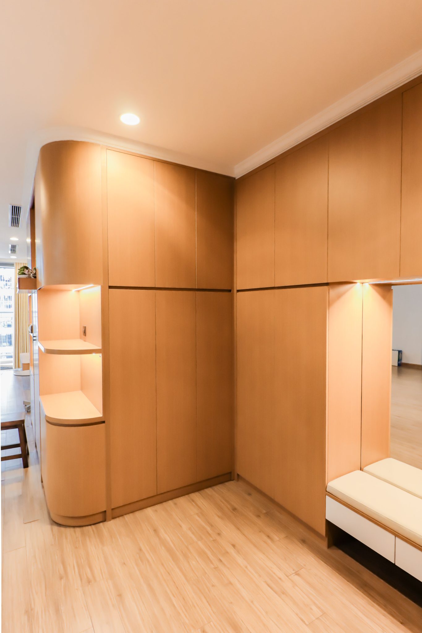 Explore a minimalist wooden interior featuring sleek built-in storage solutions. Ideal for modern home design inspiration.