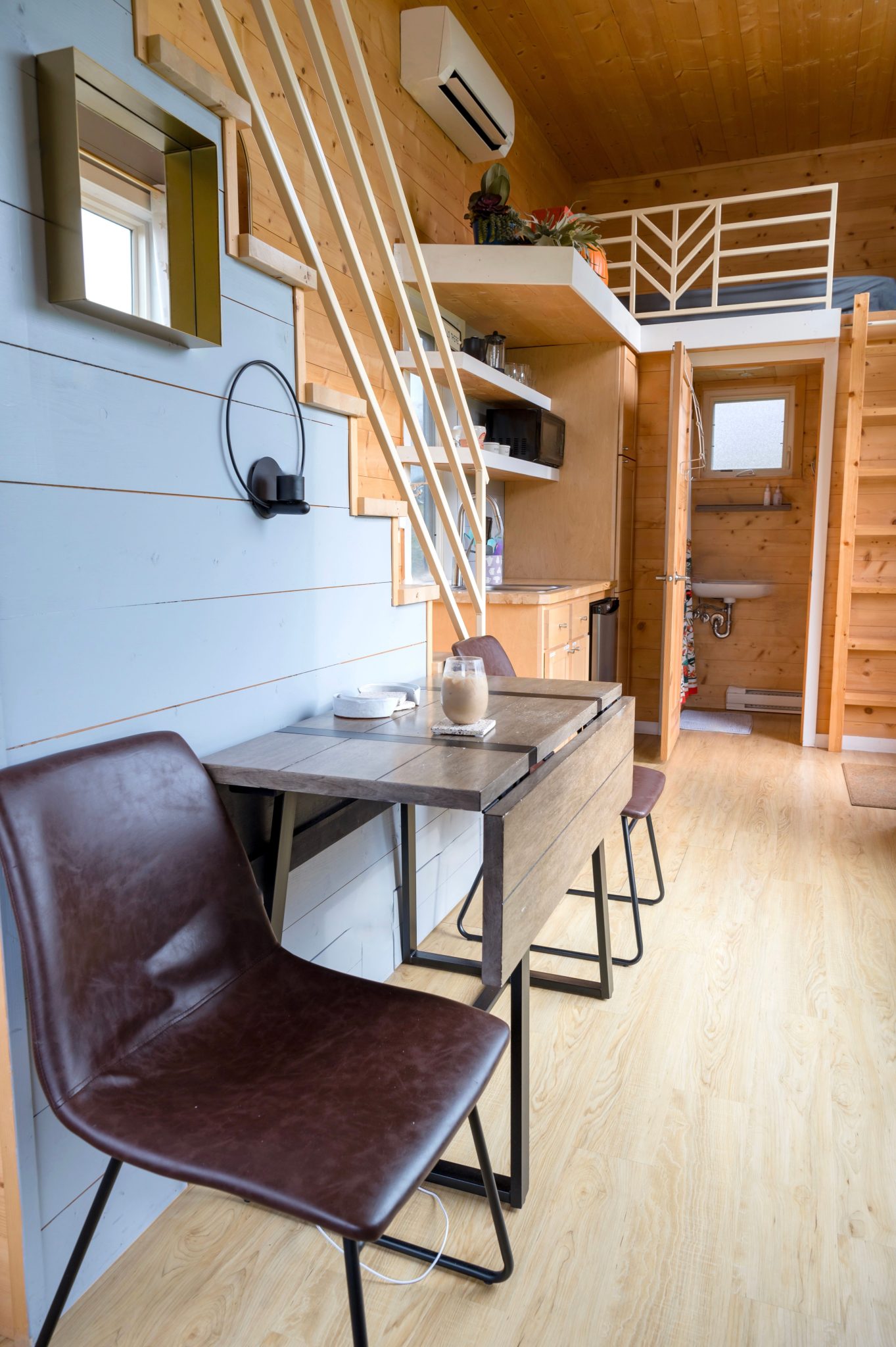 Explore the stylish interior of a modern A-frame cabin with contemporary furniture.