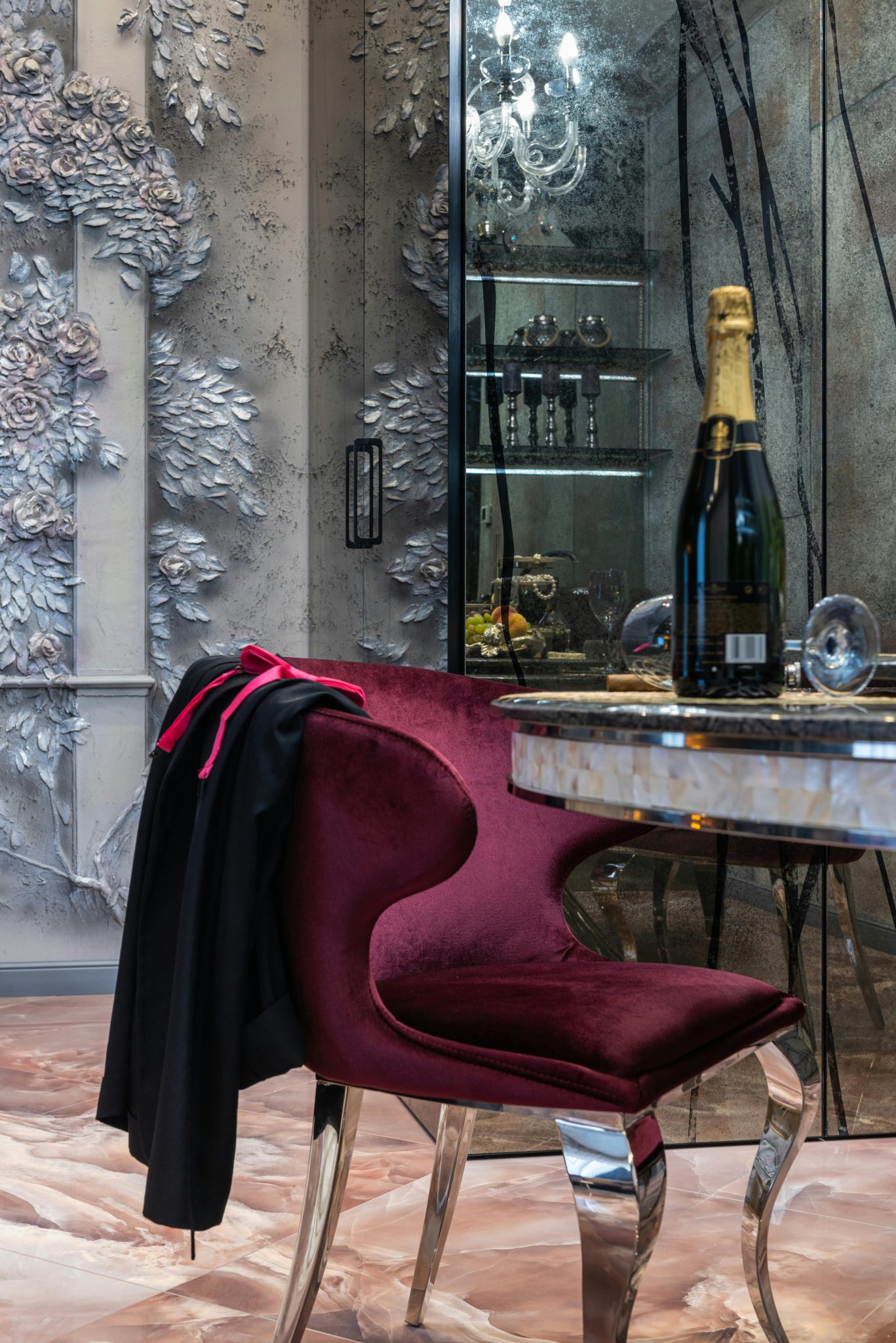 Interior of contemporary fancy living room with creative purple armchair near round table with bottle of champagne