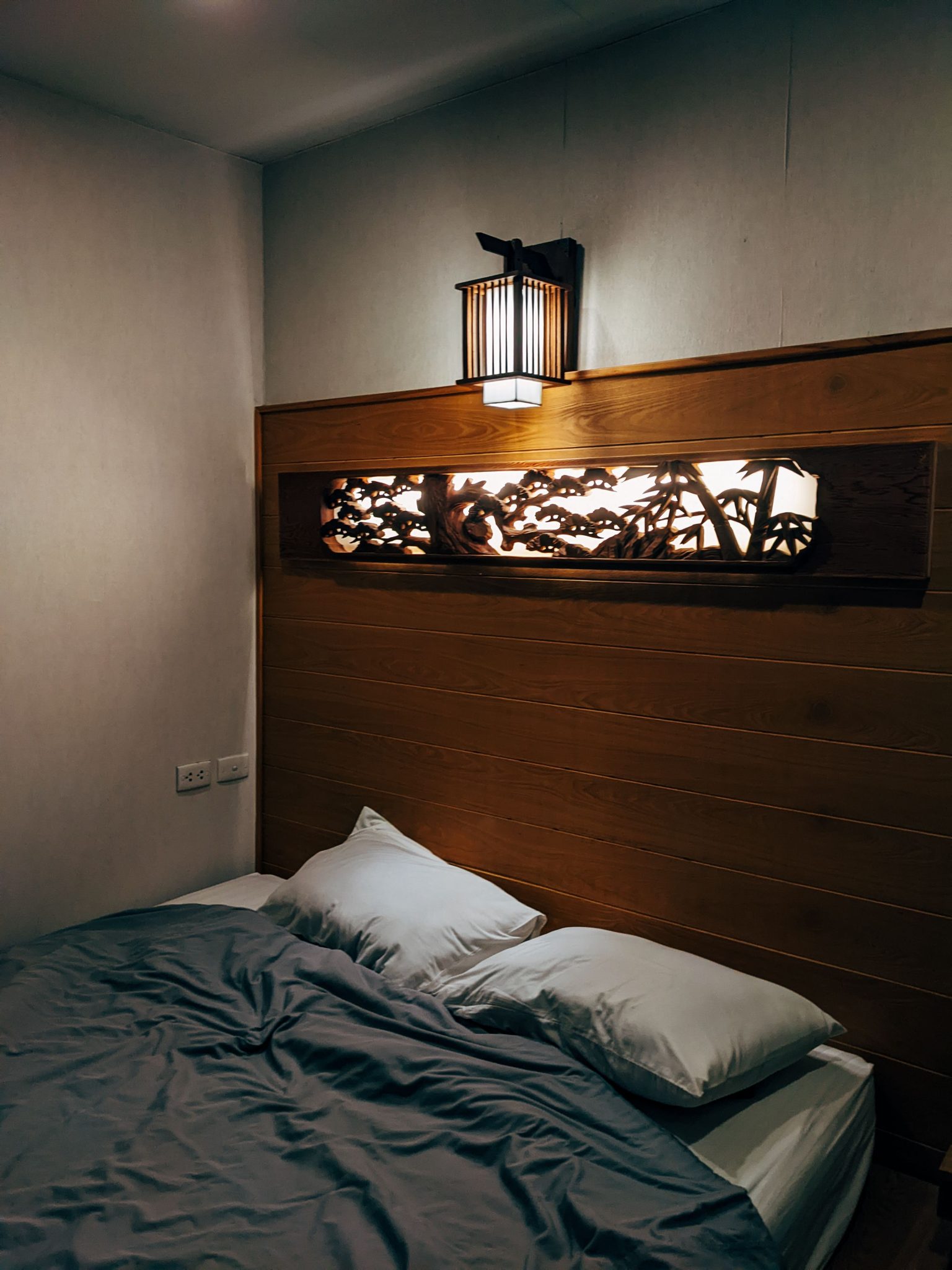 Inviting bedroom scene with soft lighting and elegant wall decor.