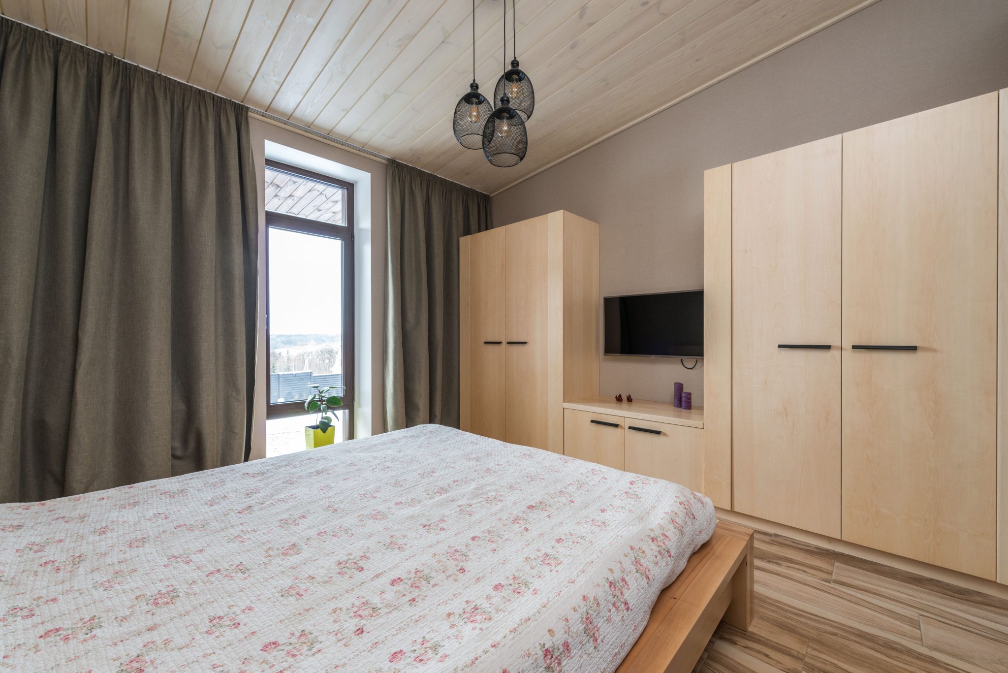 Inviting bedroom showcasing modern interior design with warm wooden elements and natural light.