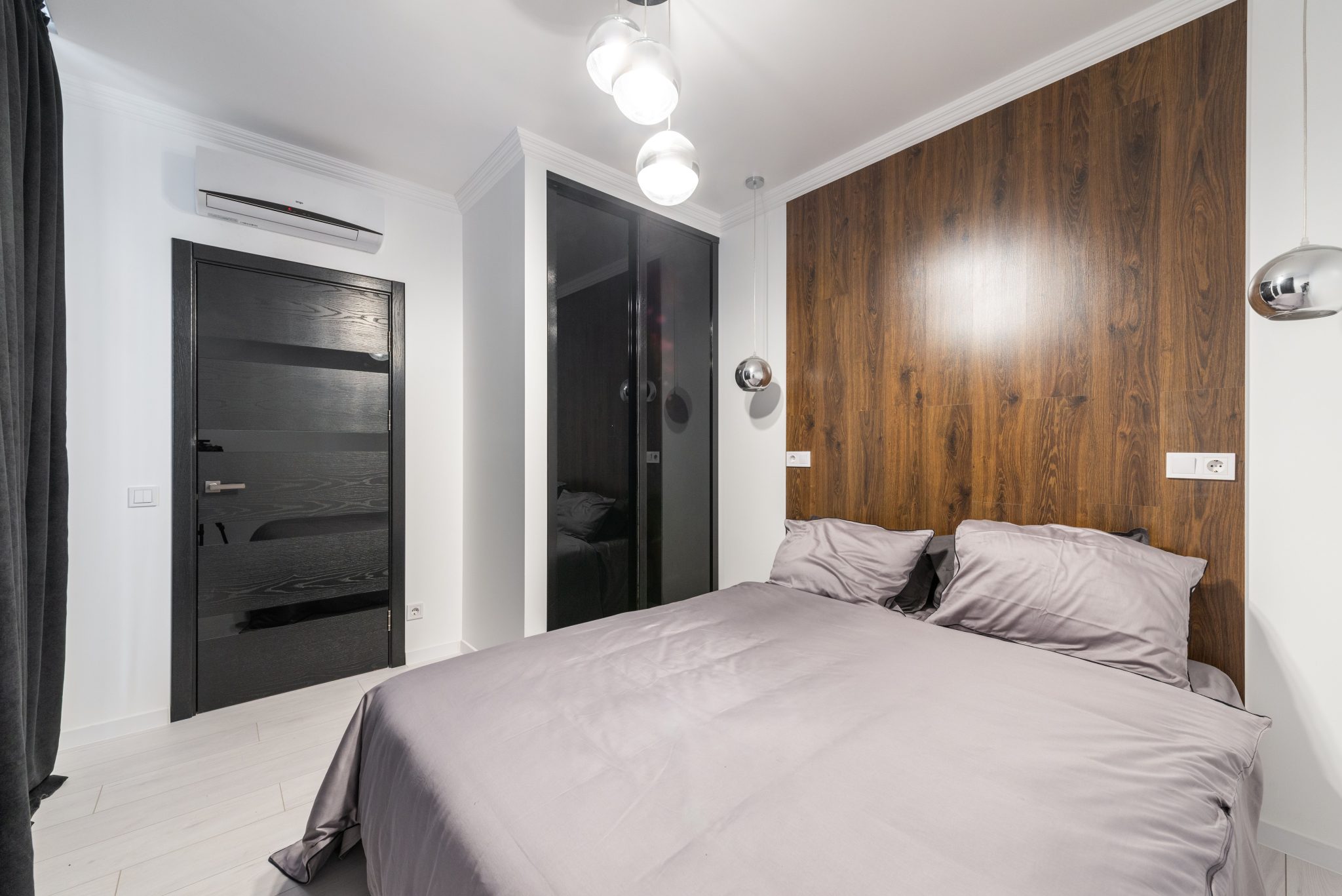 Stylish and modern bedroom interior featuring wooden accents and muted decor for a cozy ambiance.