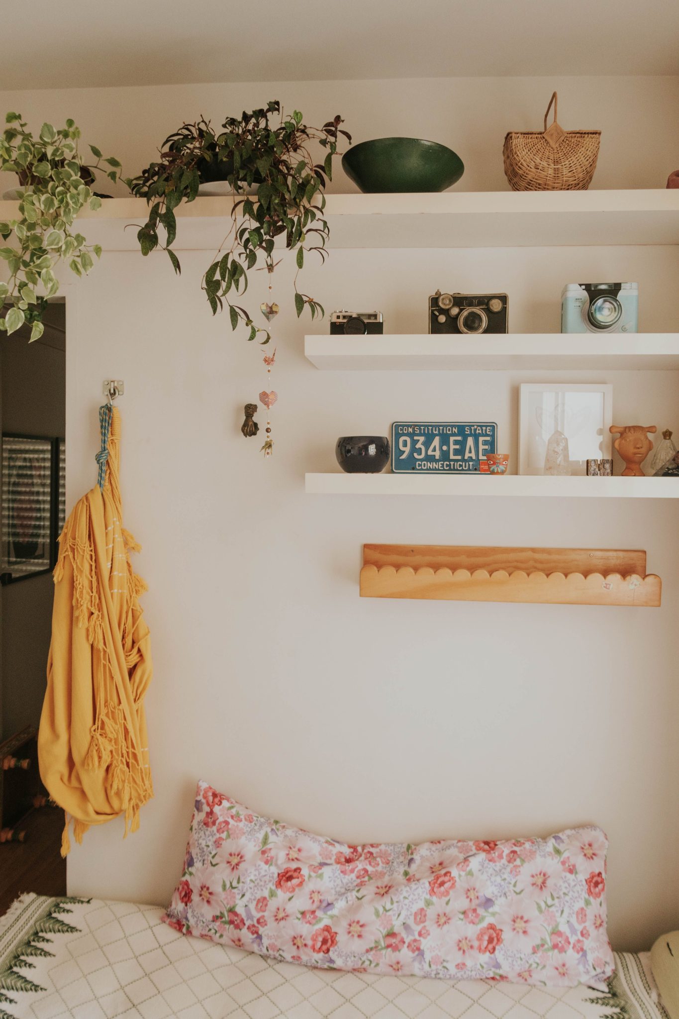 Warm and inviting bedroom interior with vintage decor, plants, and colorful textiles.