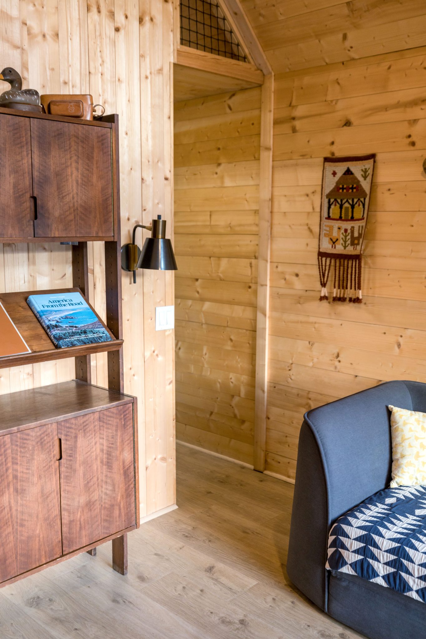 Warm and inviting cabin interior with wood paneling and rustic furnishings.