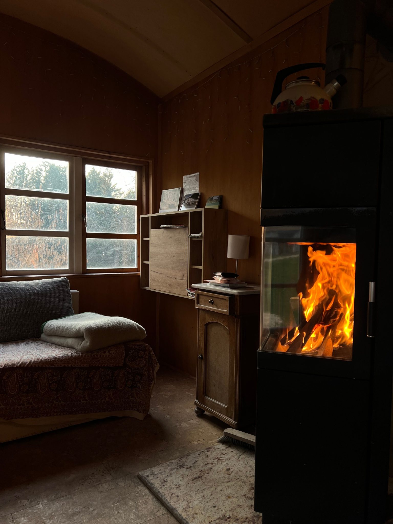 Warm and inviting cabin room interior with a crackling fireplace, perfect for a peaceful retreat.
