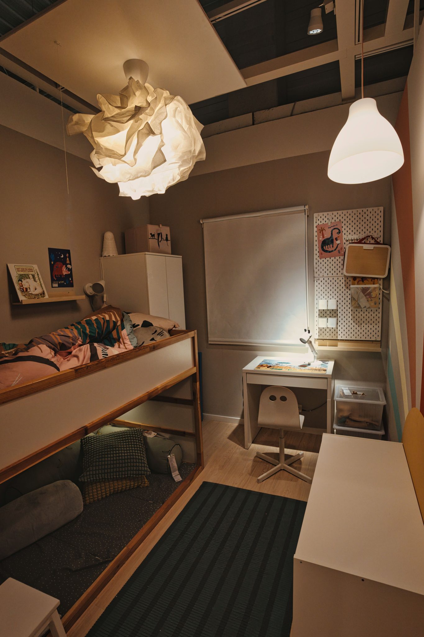 Warm and inviting children's bedroom with desk and bunk bed lighting in Berlin apartment.