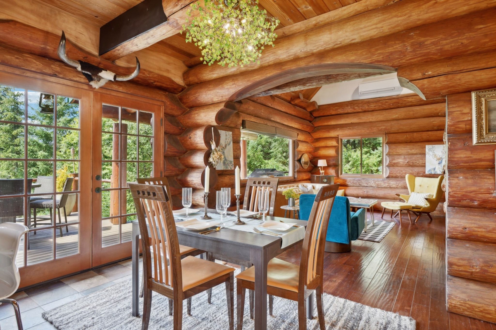 Warm and inviting log cabin interior featuring a dining area with natural wood accents and scenic views.
