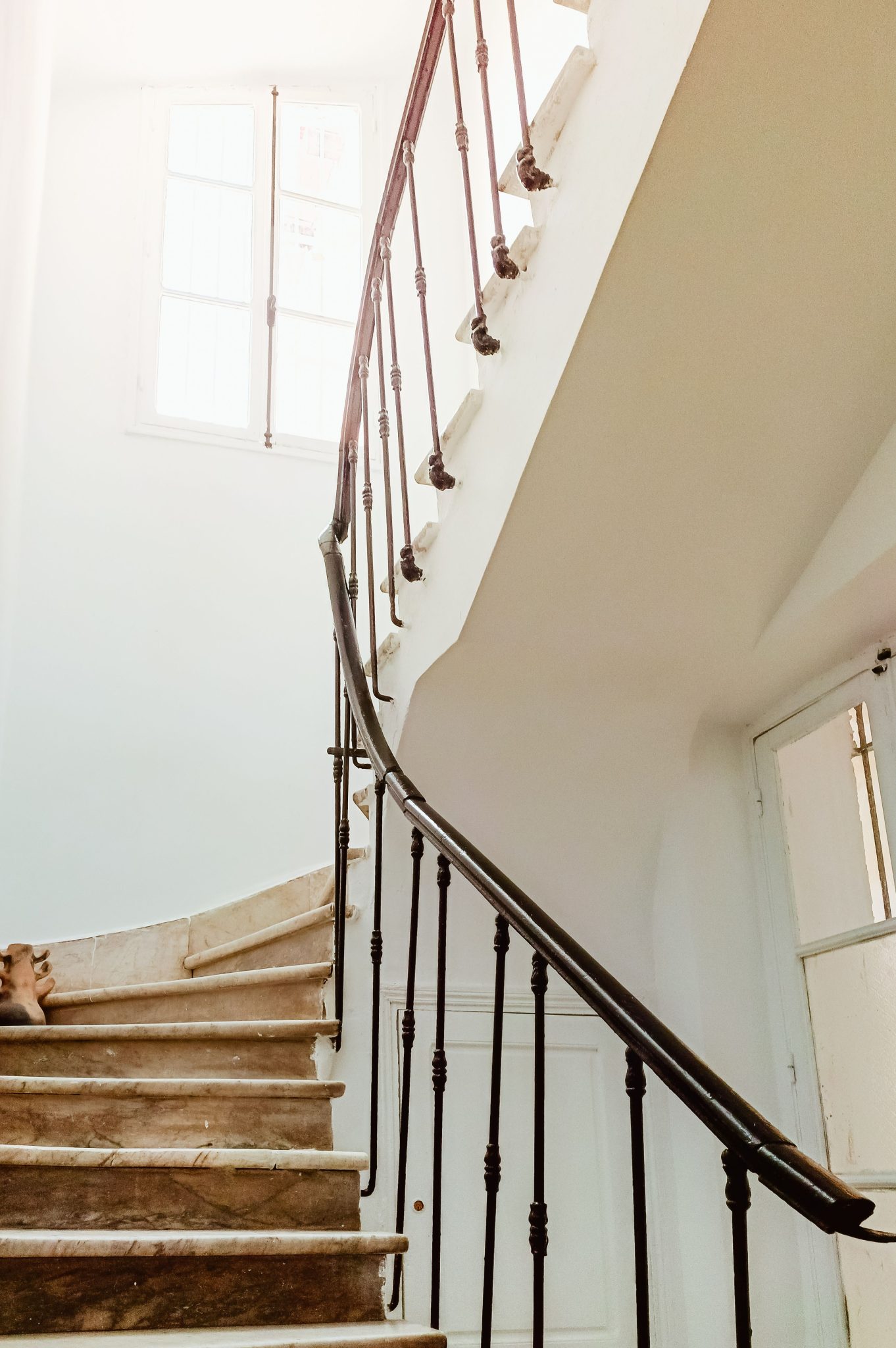 A beautifully lit spiral staircase in a Tunisian house, capturing architectural elegance.