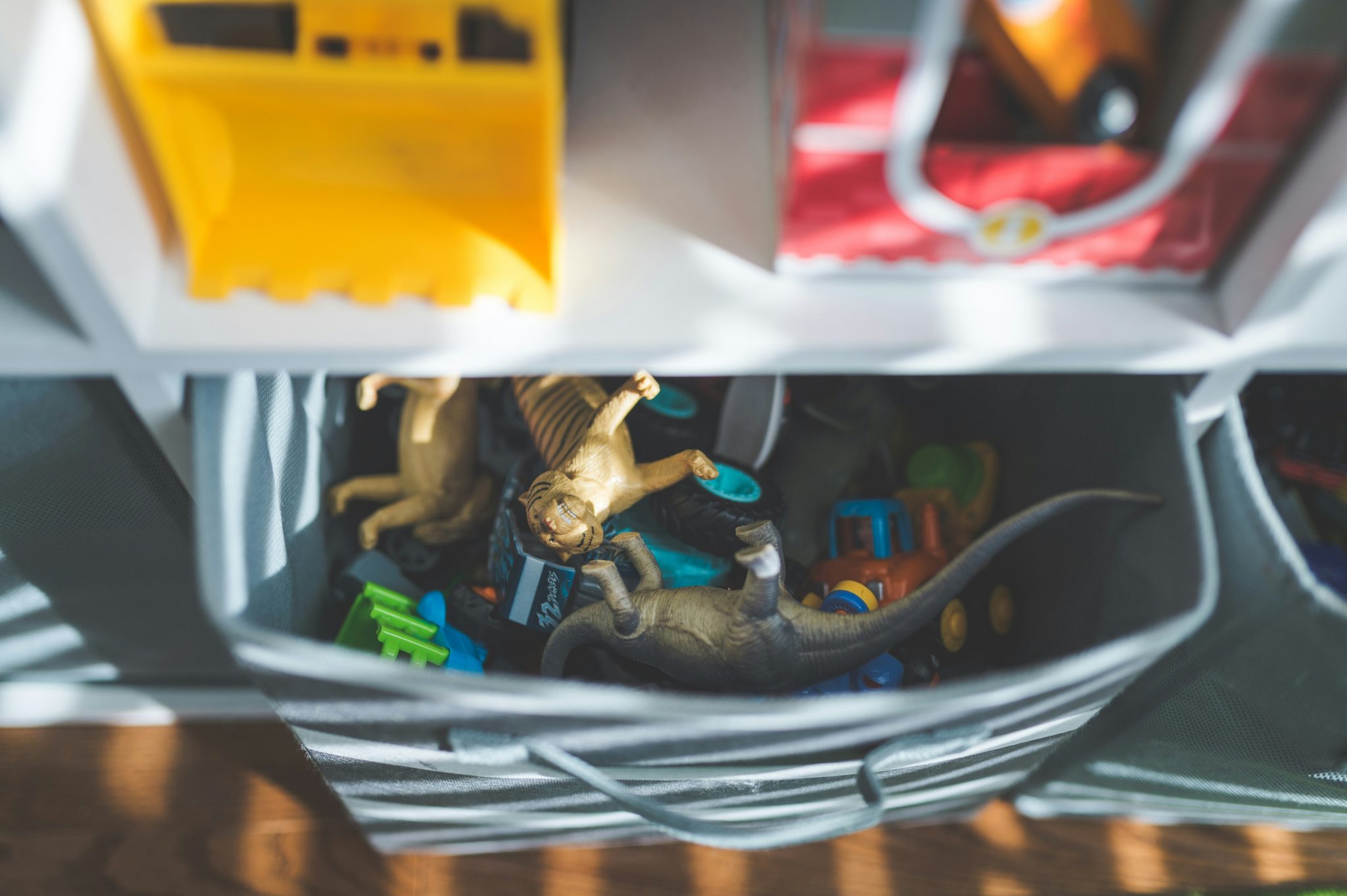 a close up of toys in a toy storage bin