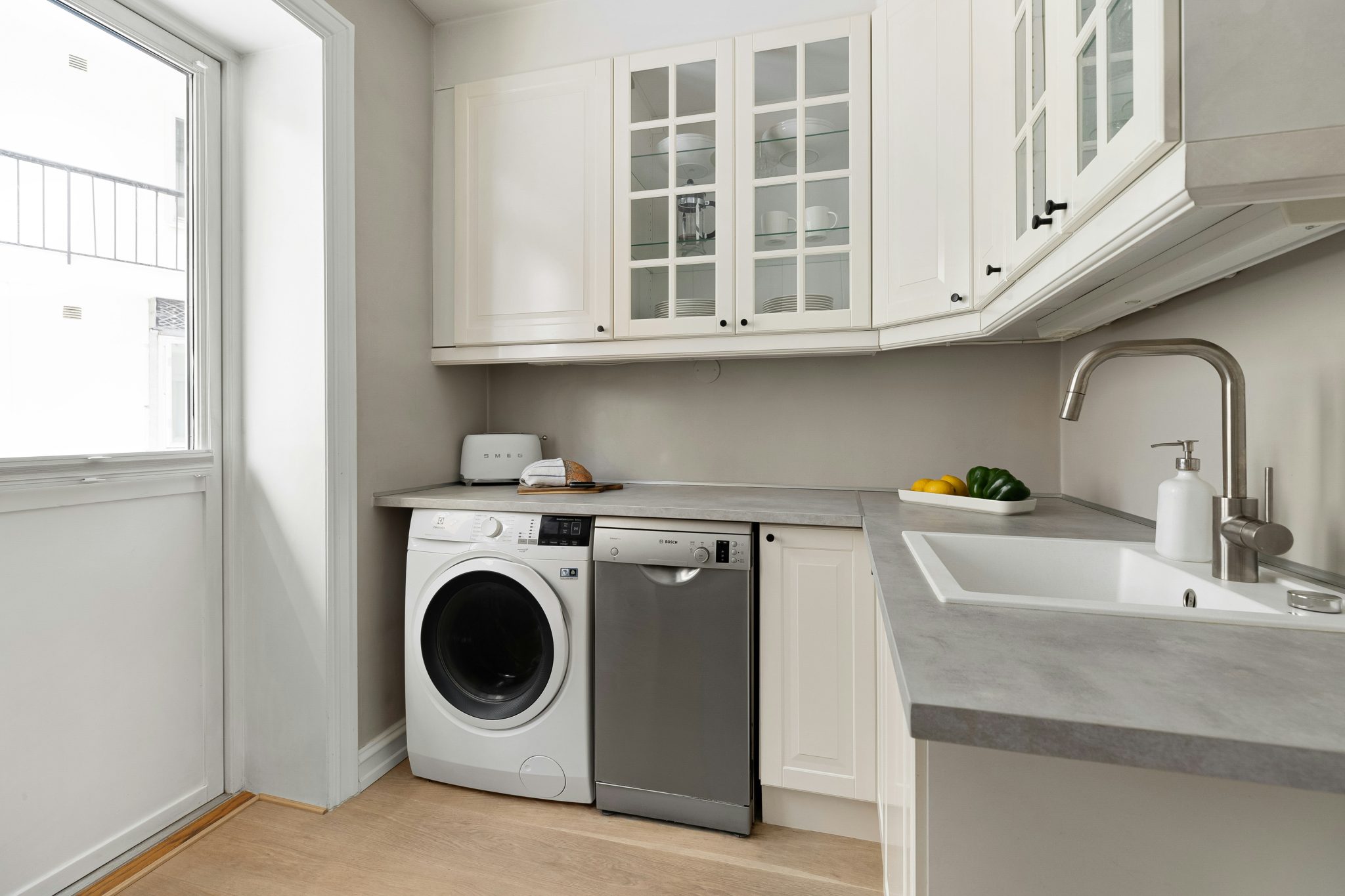 A kitchen with a washer and dryer in it