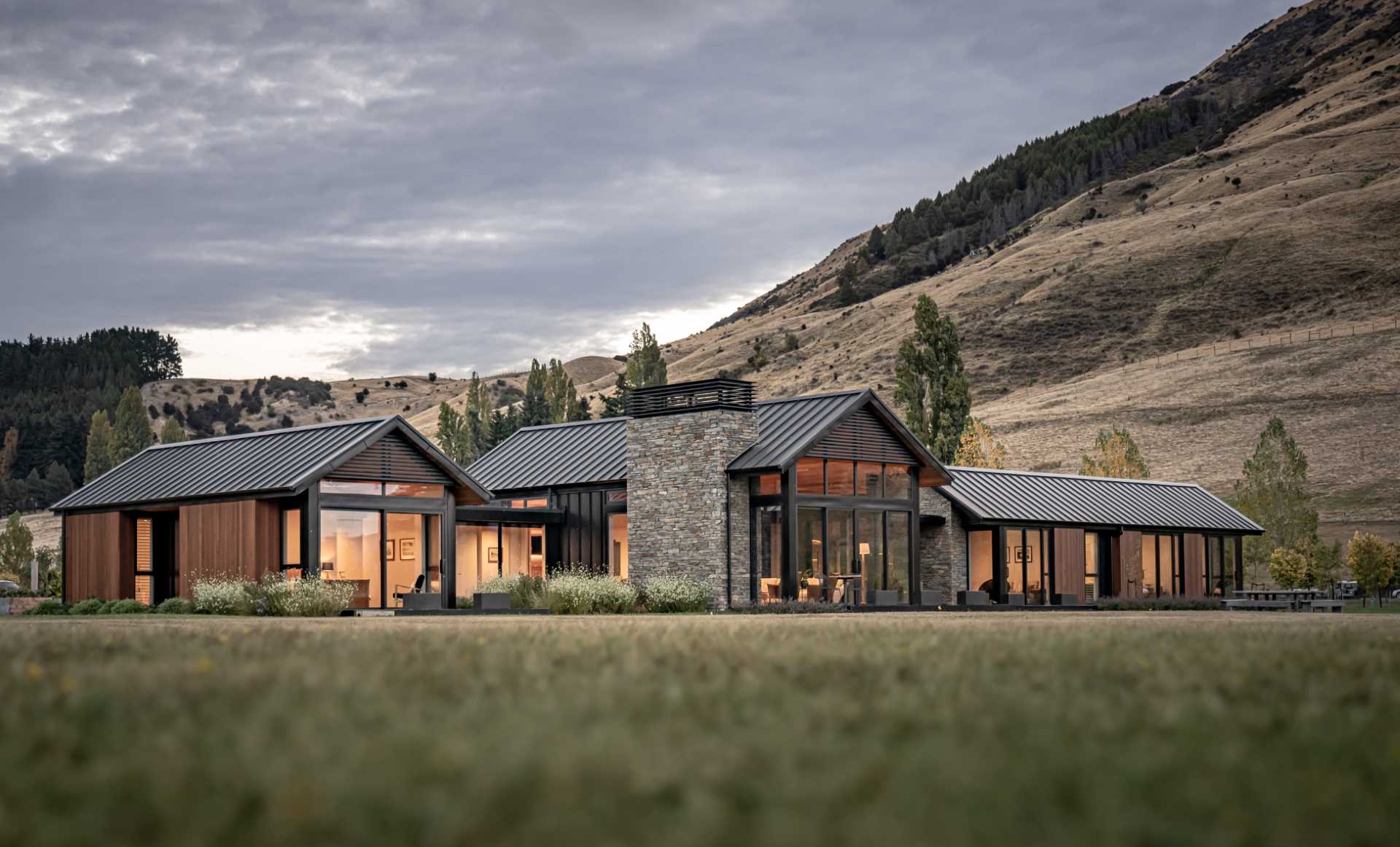 A Material Palette Of Cedar, Stone, And Metal Contribute To The Charm Of This Farmhouse-Inspired Home - Design Skill Magazine