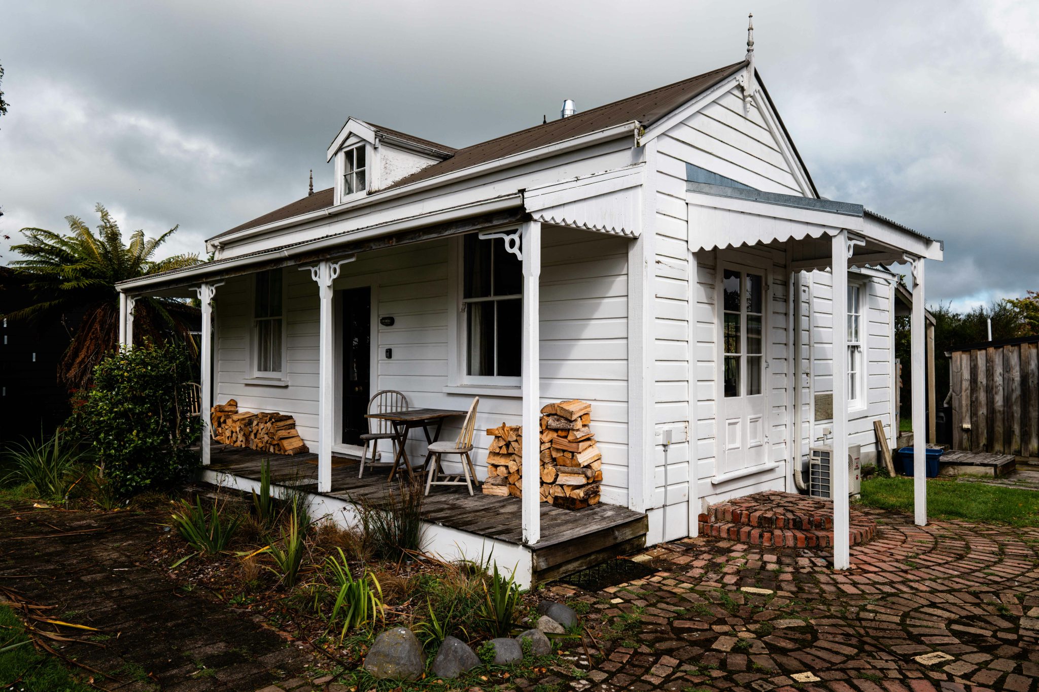 A small white house with a covered porch.
