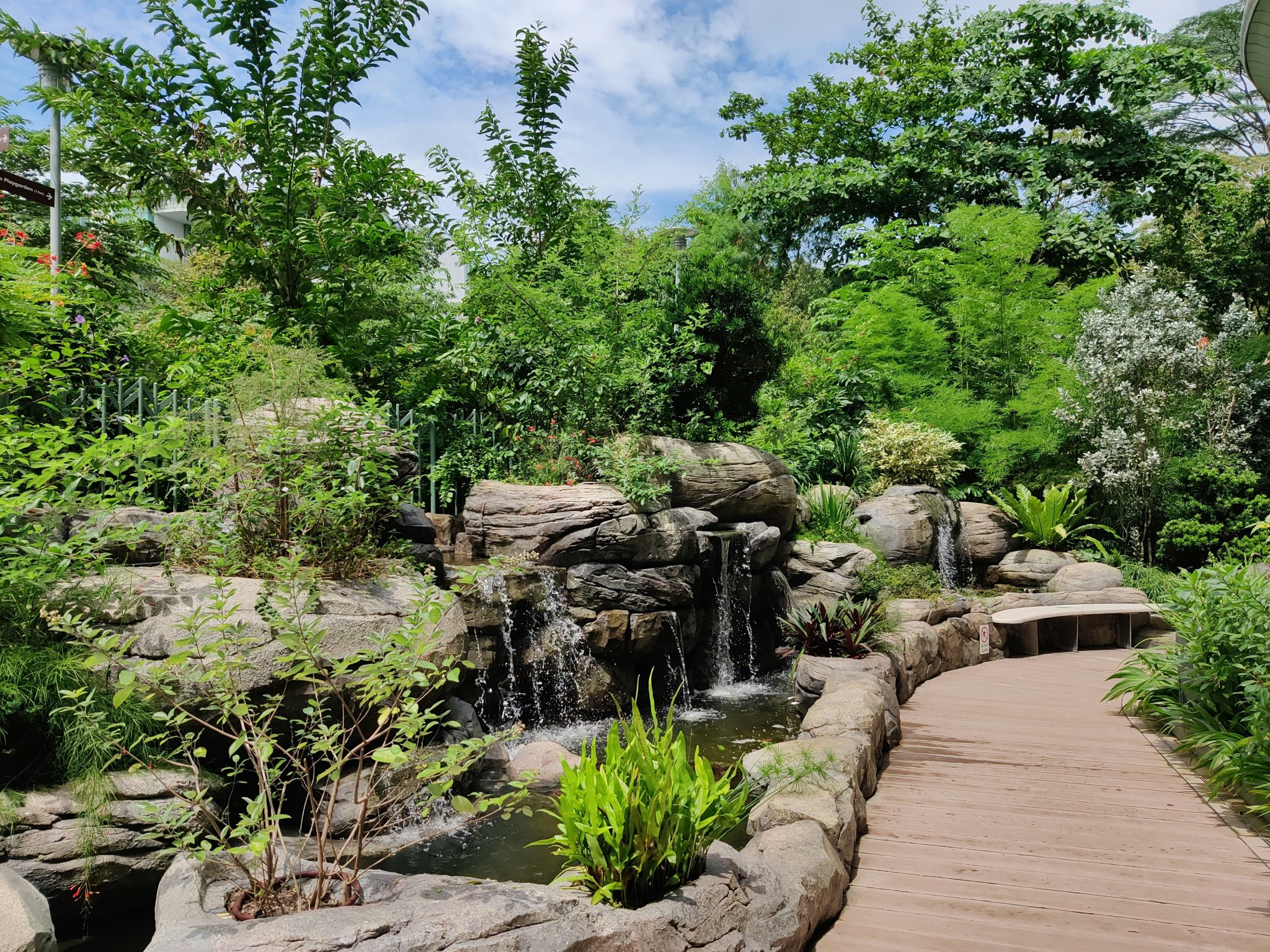 Am outdoor footpath next to beautiful water feature and landscape