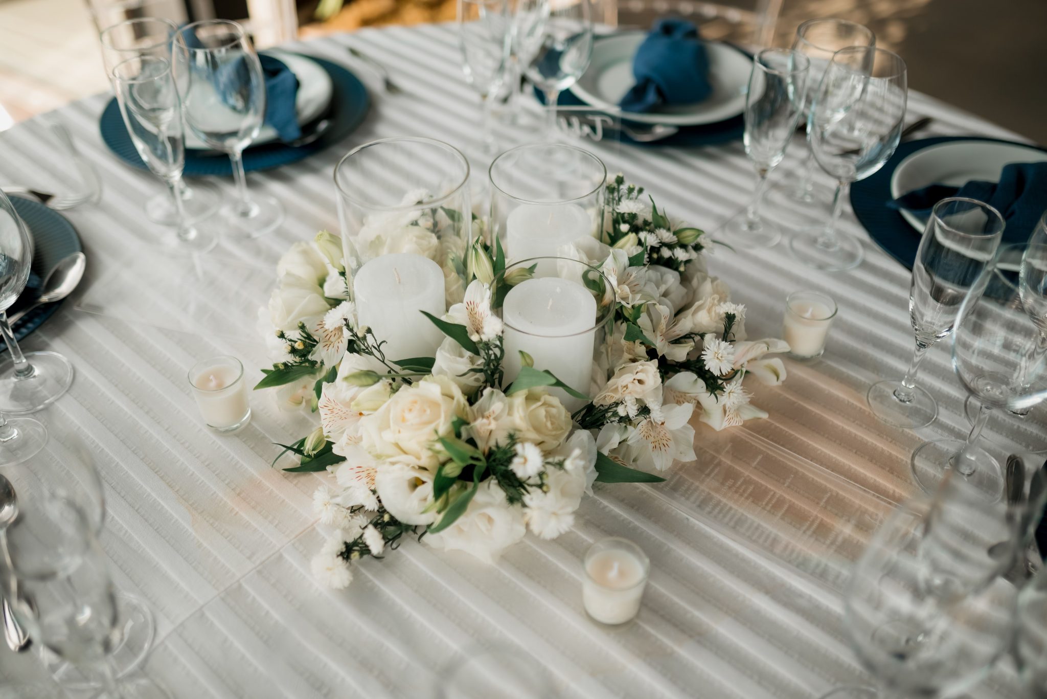 Beautiful wedding table centerpiece with white flowers and candles, perfect for special occasions.