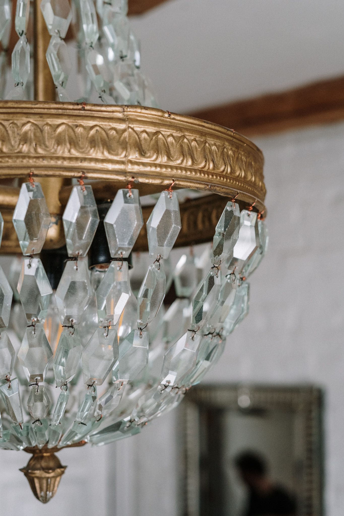 Close-up of a luxurious crystal chandelier with ornate design elements.