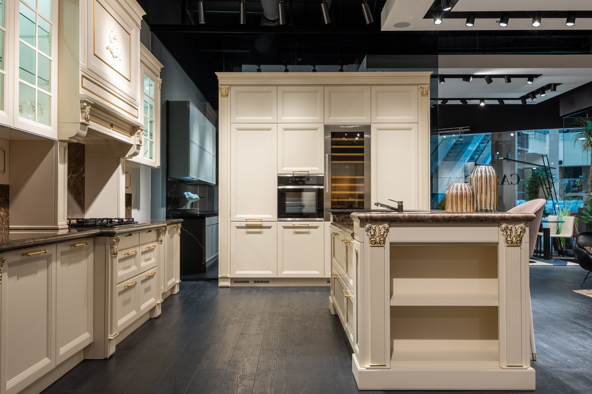 Contemporary stylish kitchen interior designed furnished with classy white units and counter in spacious modern apartment