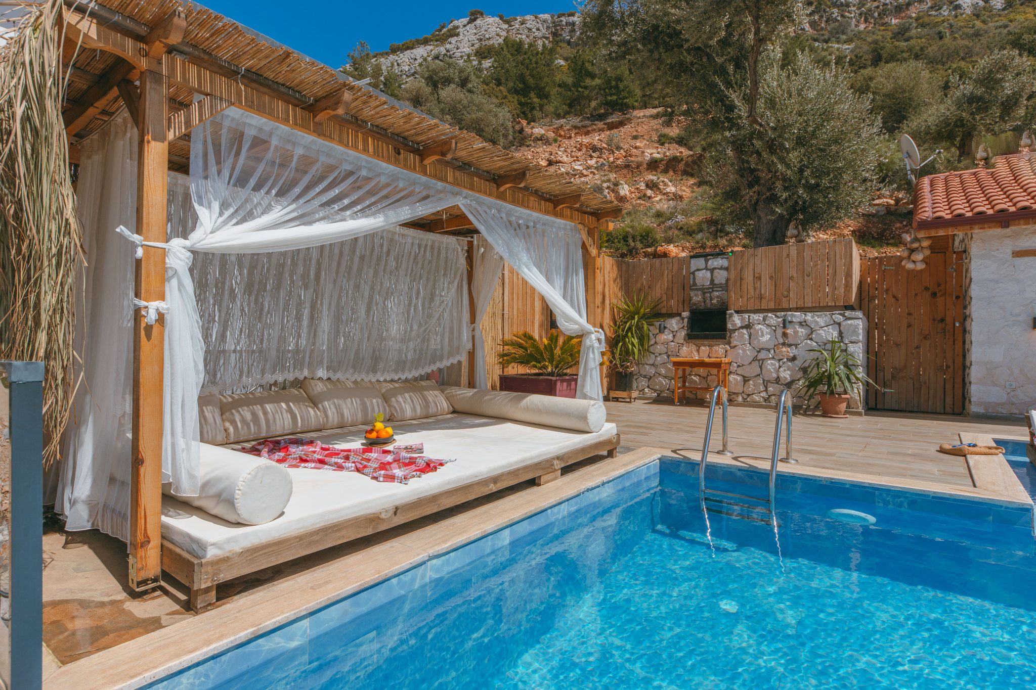Enjoy a serene retreat with a luxury cabana by the pool at a Mediterranean villa.