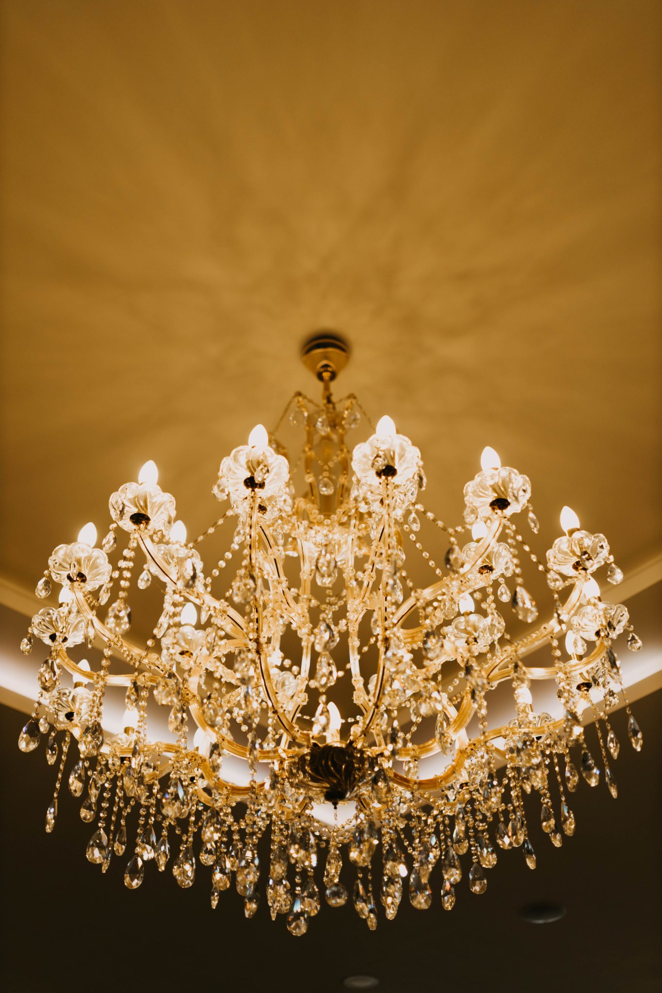 Luxurious crystal chandelier illuminating an elegant room, creating a warm and inviting atmosphere.