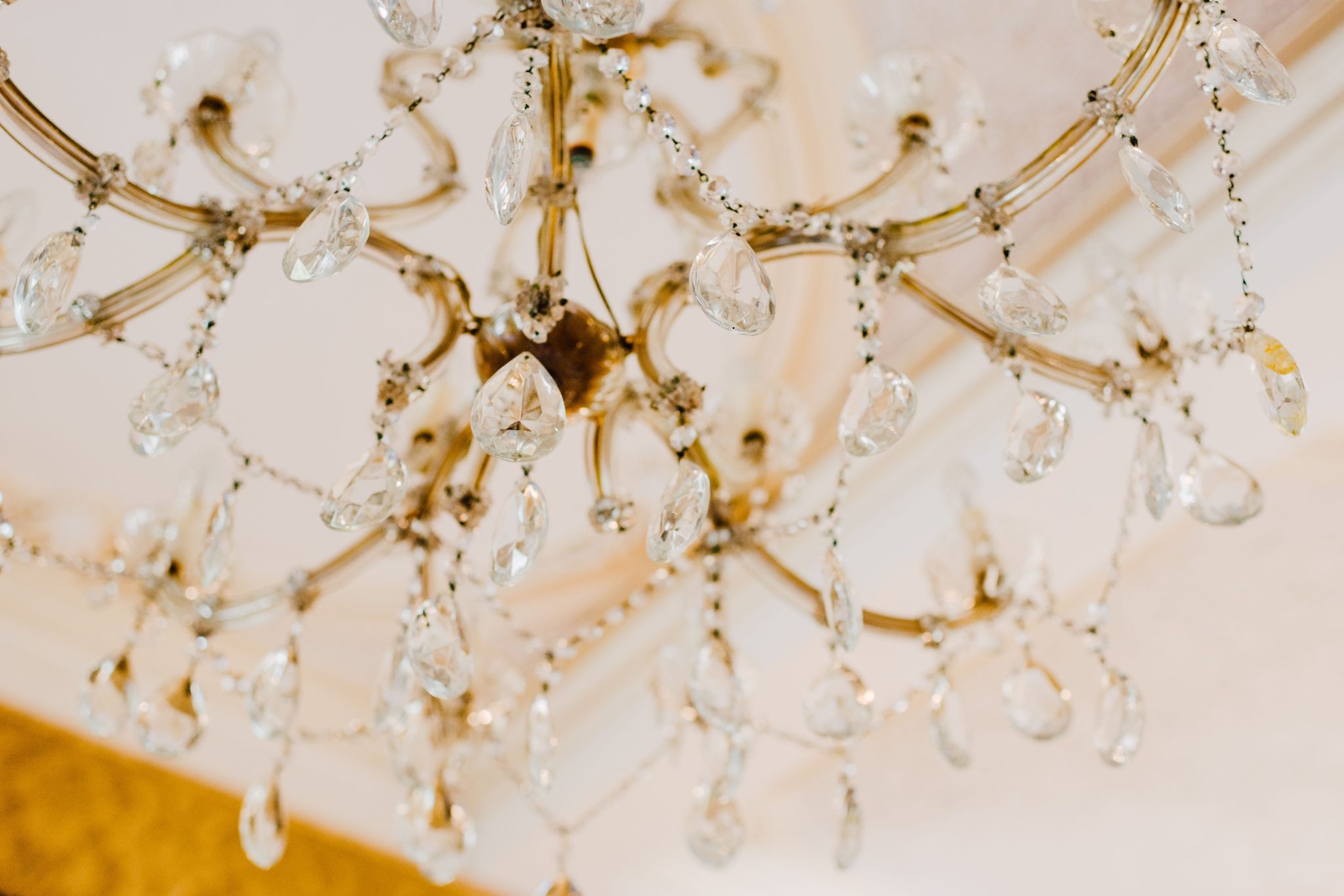 Luxurious gold and crystal chandelier showcasing elegance and glamour.
