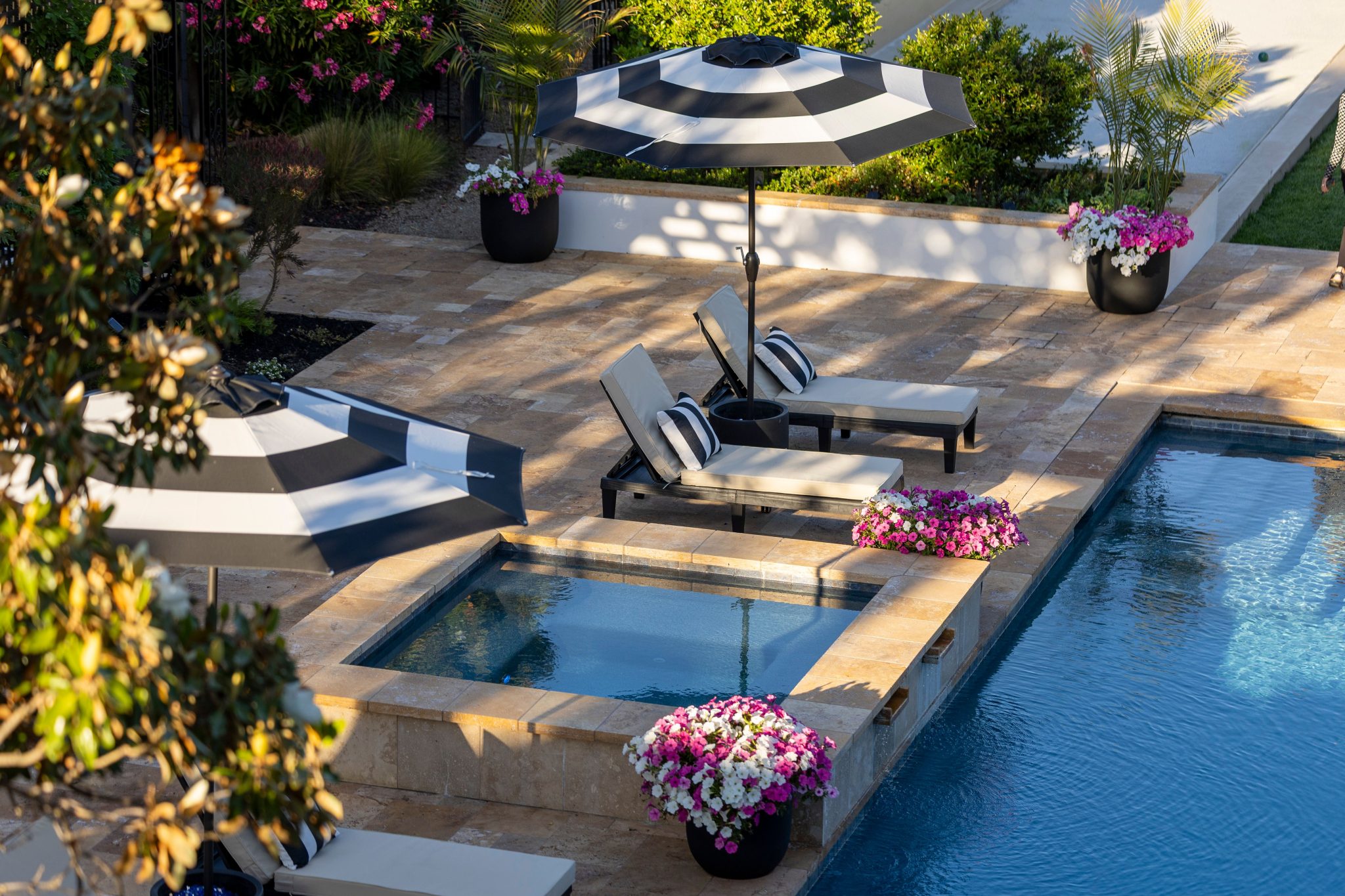 Luxurious poolside scene with lounge chairs and floral arrangements, perfect for relaxation.