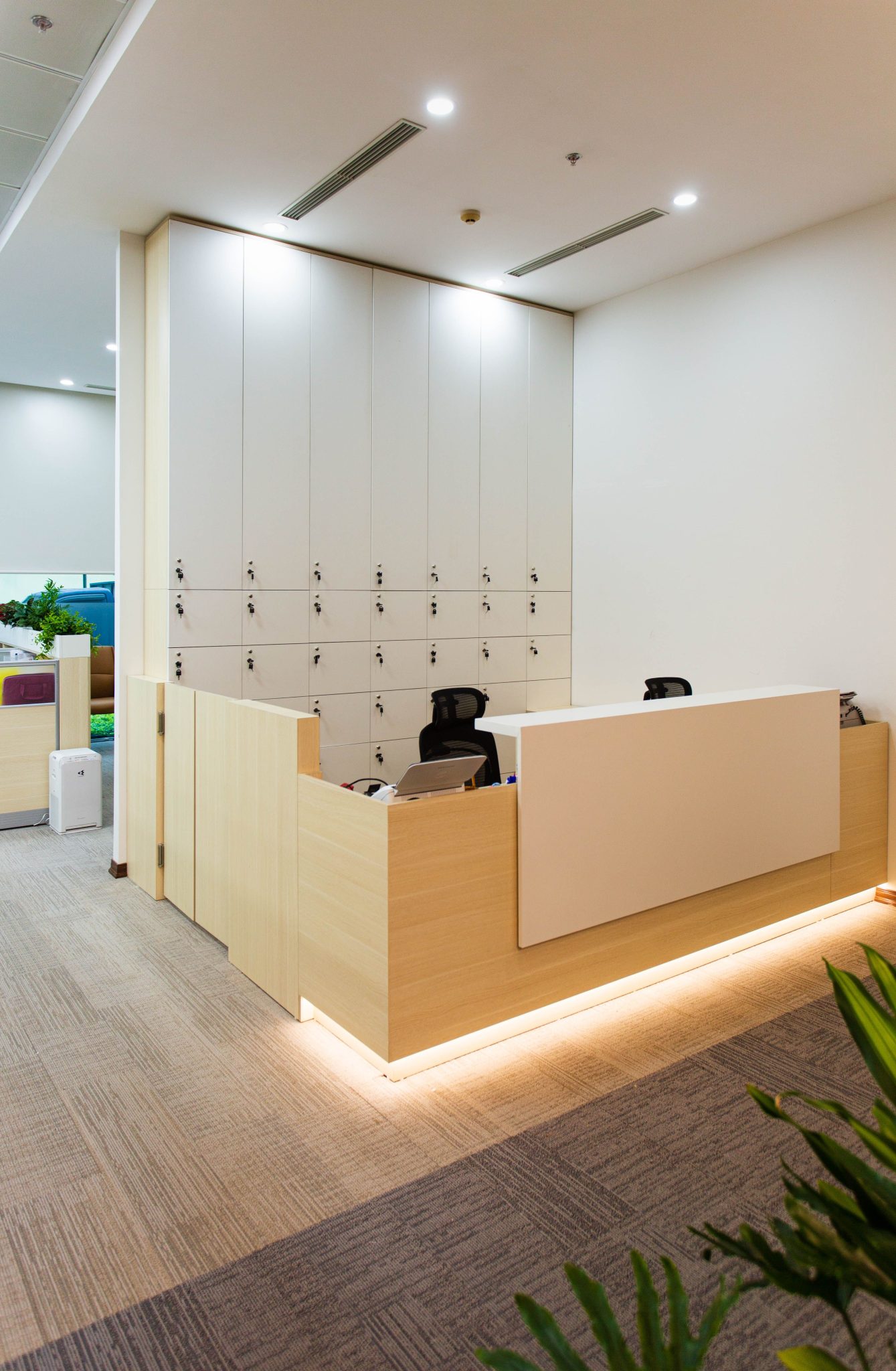 Sleek and modern office reception area with a minimalist design and built-in lighting.