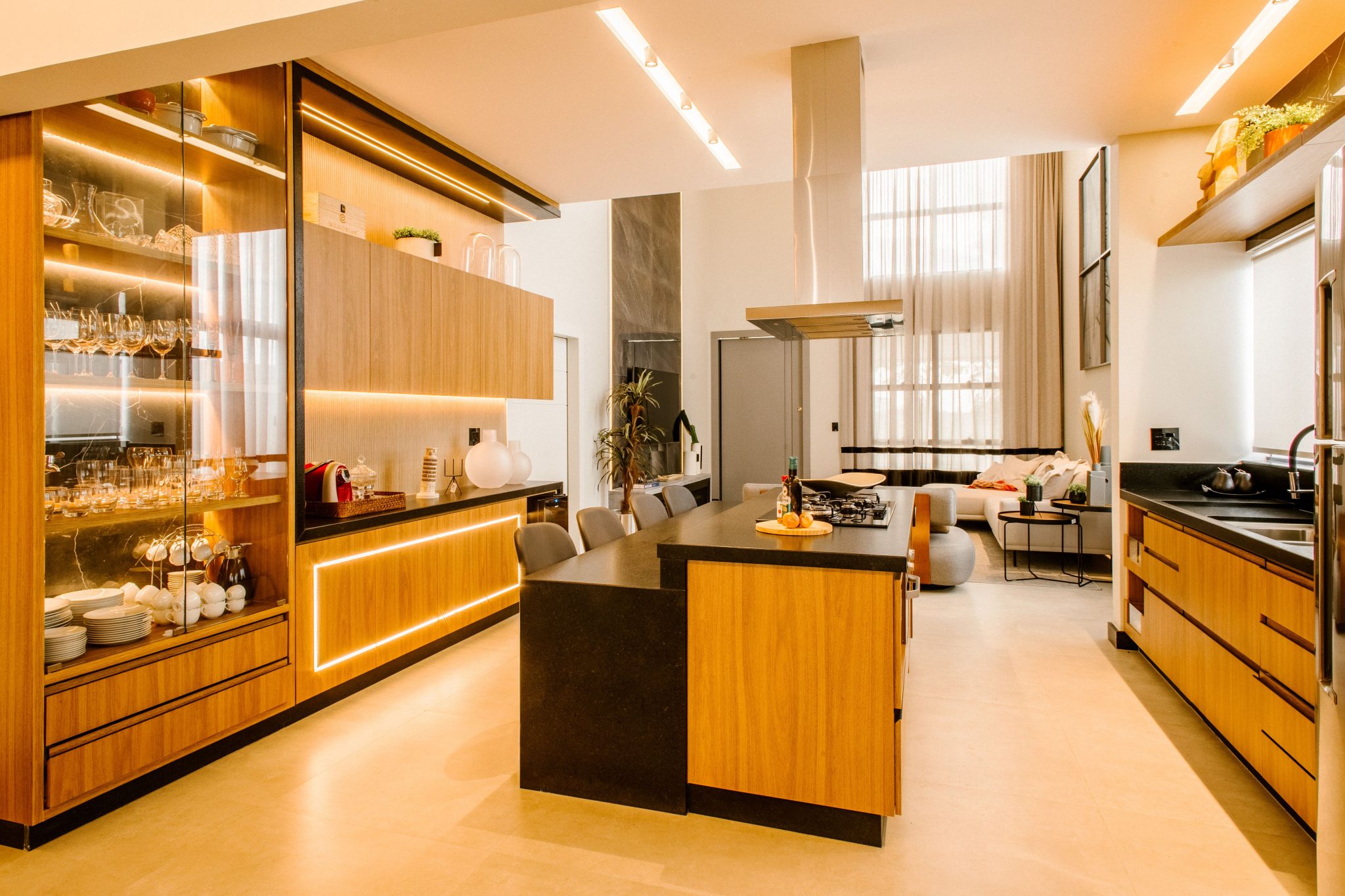 Sleek modern kitchen featuring wooden cabinetry and elegant lighting.