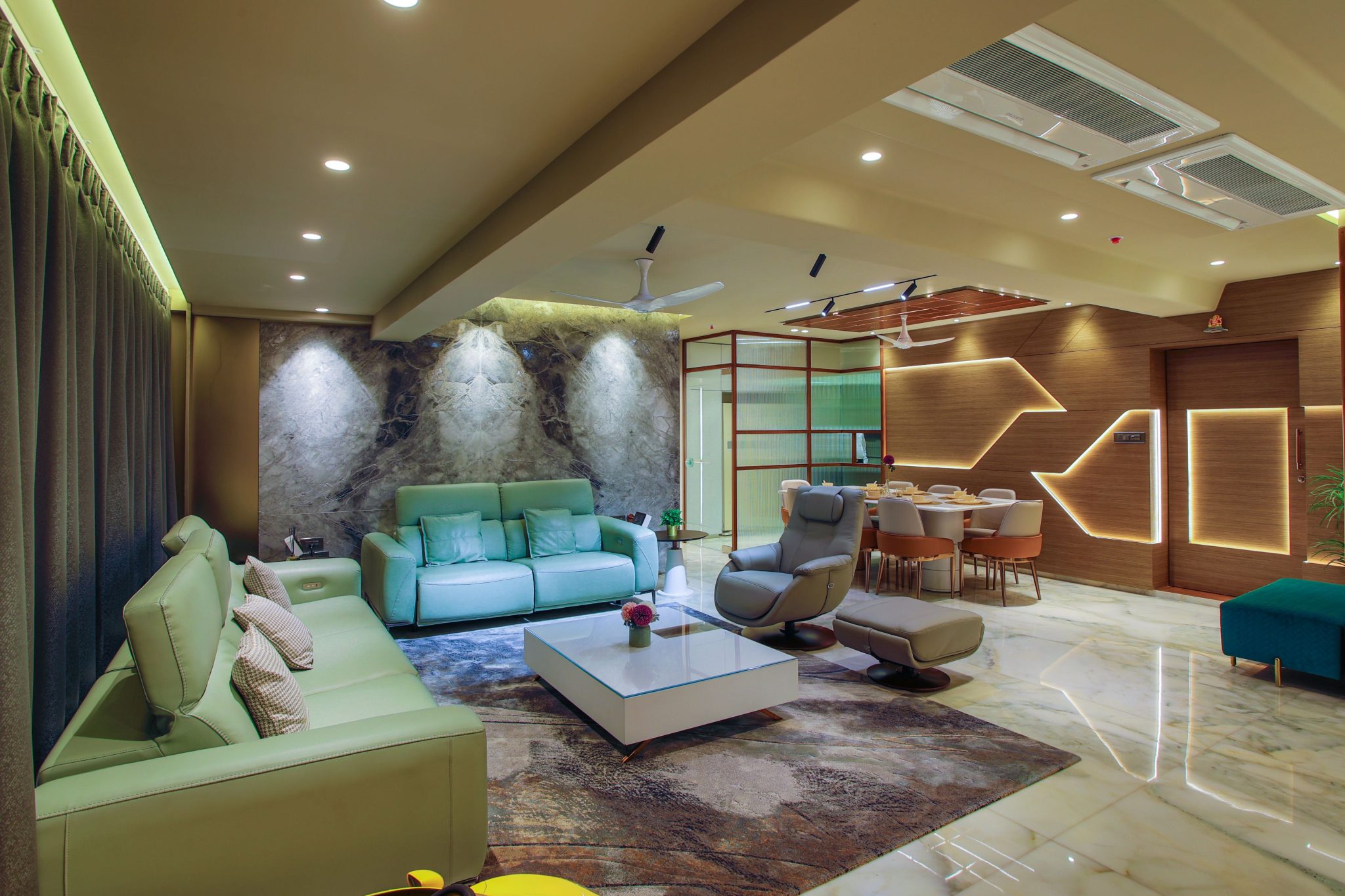 Spacious and stylishly designed modern living room with elegant furniture and ambient lighting.