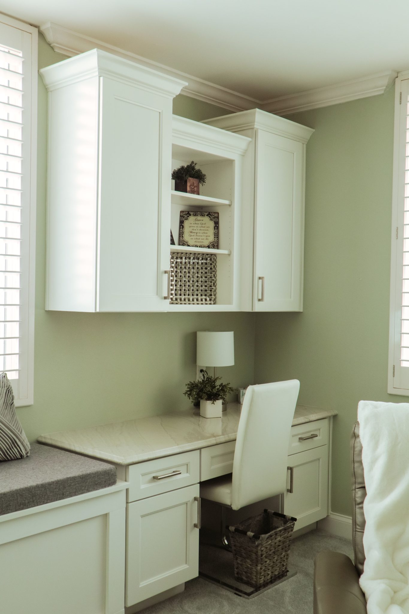 Stylish home office space with white cabinets and marble desk, perfect for luxury interior design enthusiasts.
