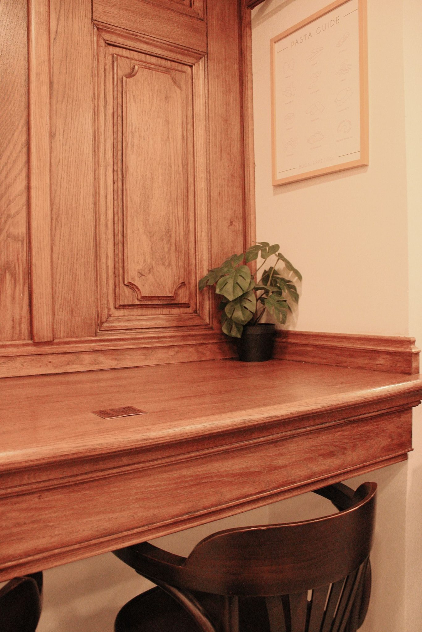 Warm and inviting study nook with wooden desk and indoor plant. Perfect for workspace inspiration.