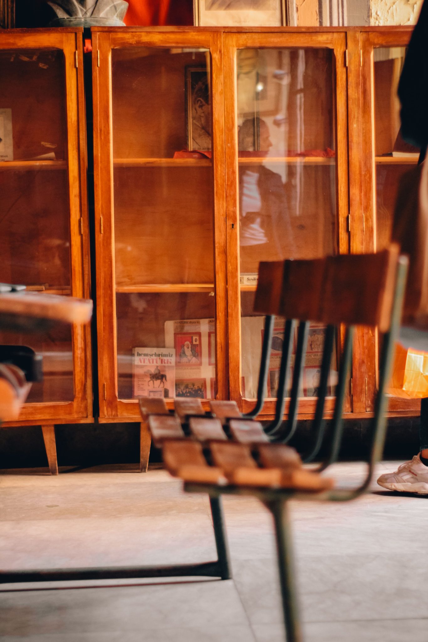 Warm vintage-style room featuring wooden cabinets and chairs. Invitational and cozy interior design.