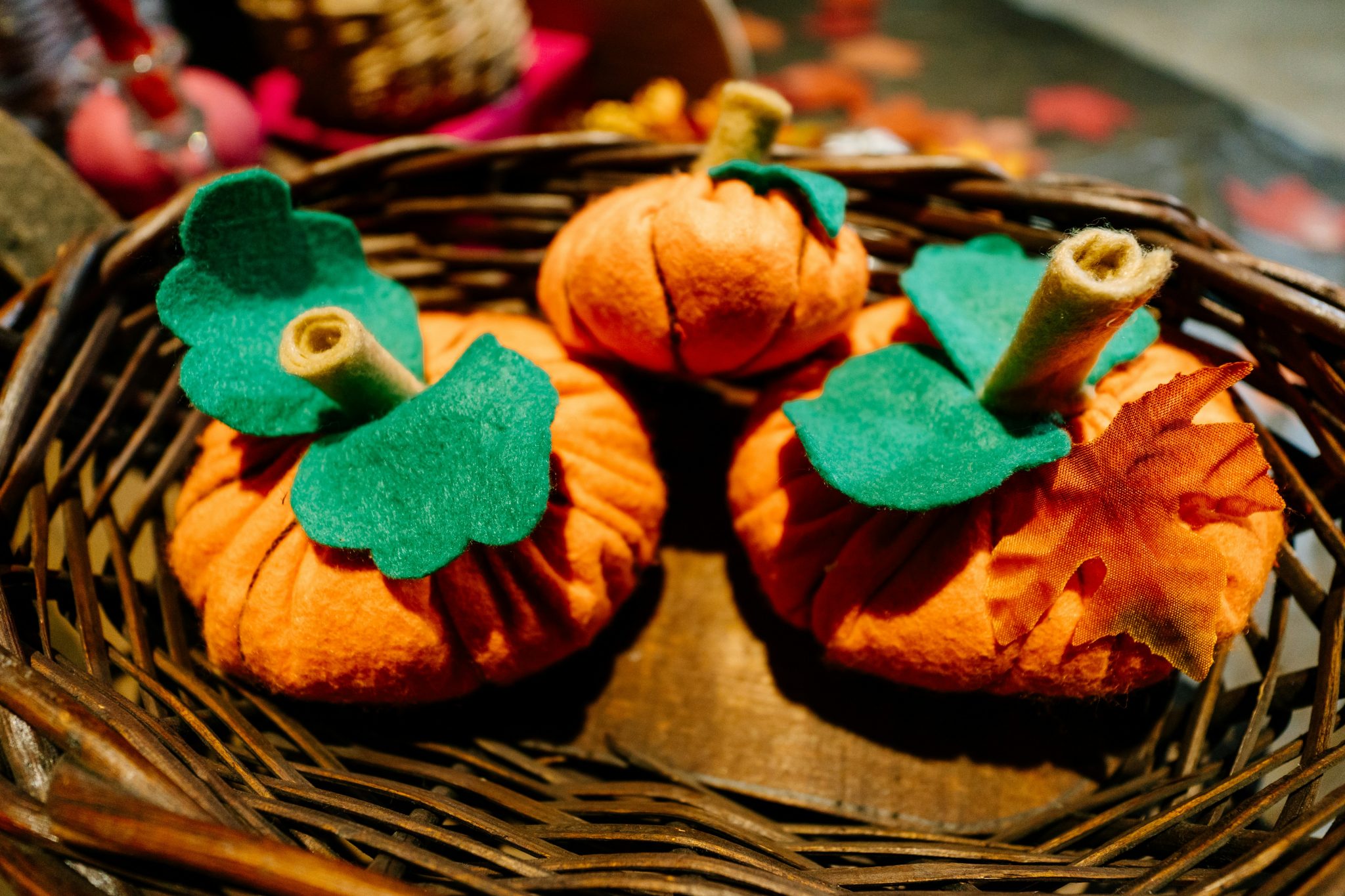 a basket filled with small pumpkins sitting on top of a table