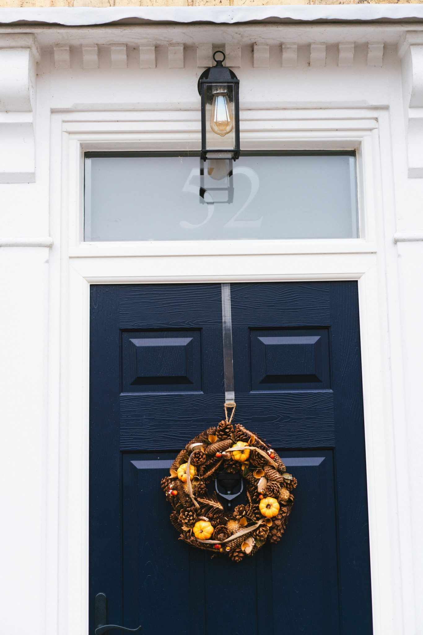 A blue door with a wreath hanging on it