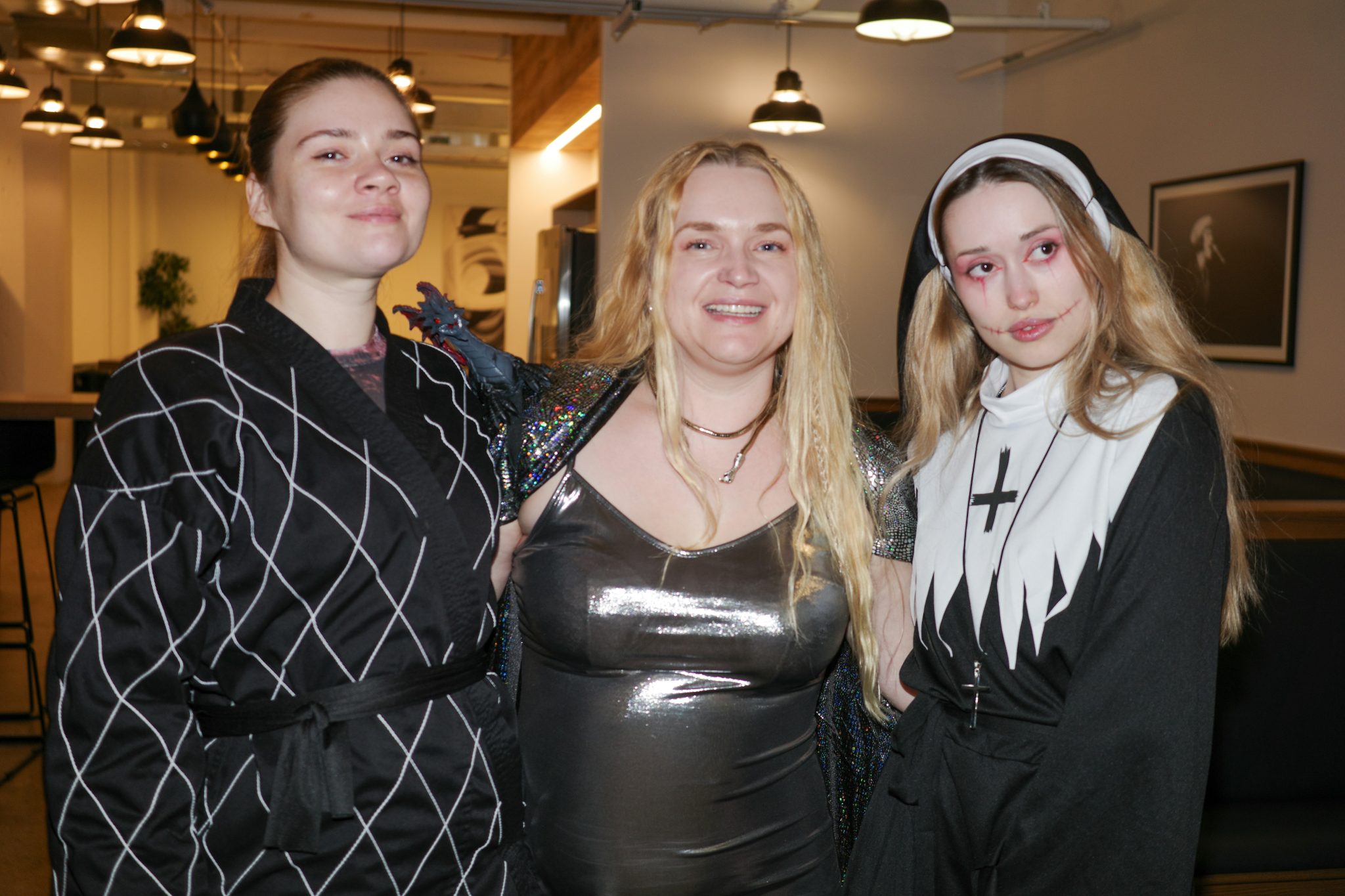 A candid black-and-white moment from a Ukrainian Halloween party. Costumes, makeup, and expressive gestures capture creativity, community, and cultural identity in a festive nighttime setting. The mon