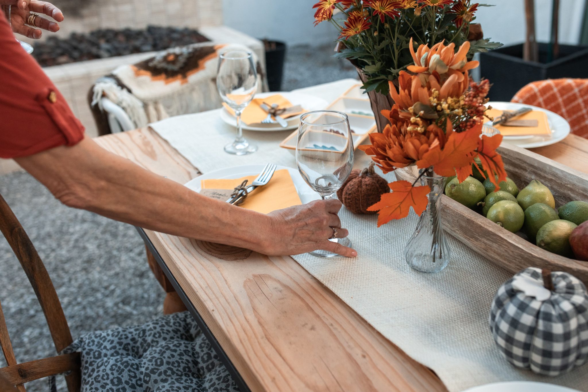 A cozy fall table setting with vibrant autumn flowers and elegant dining accessories.