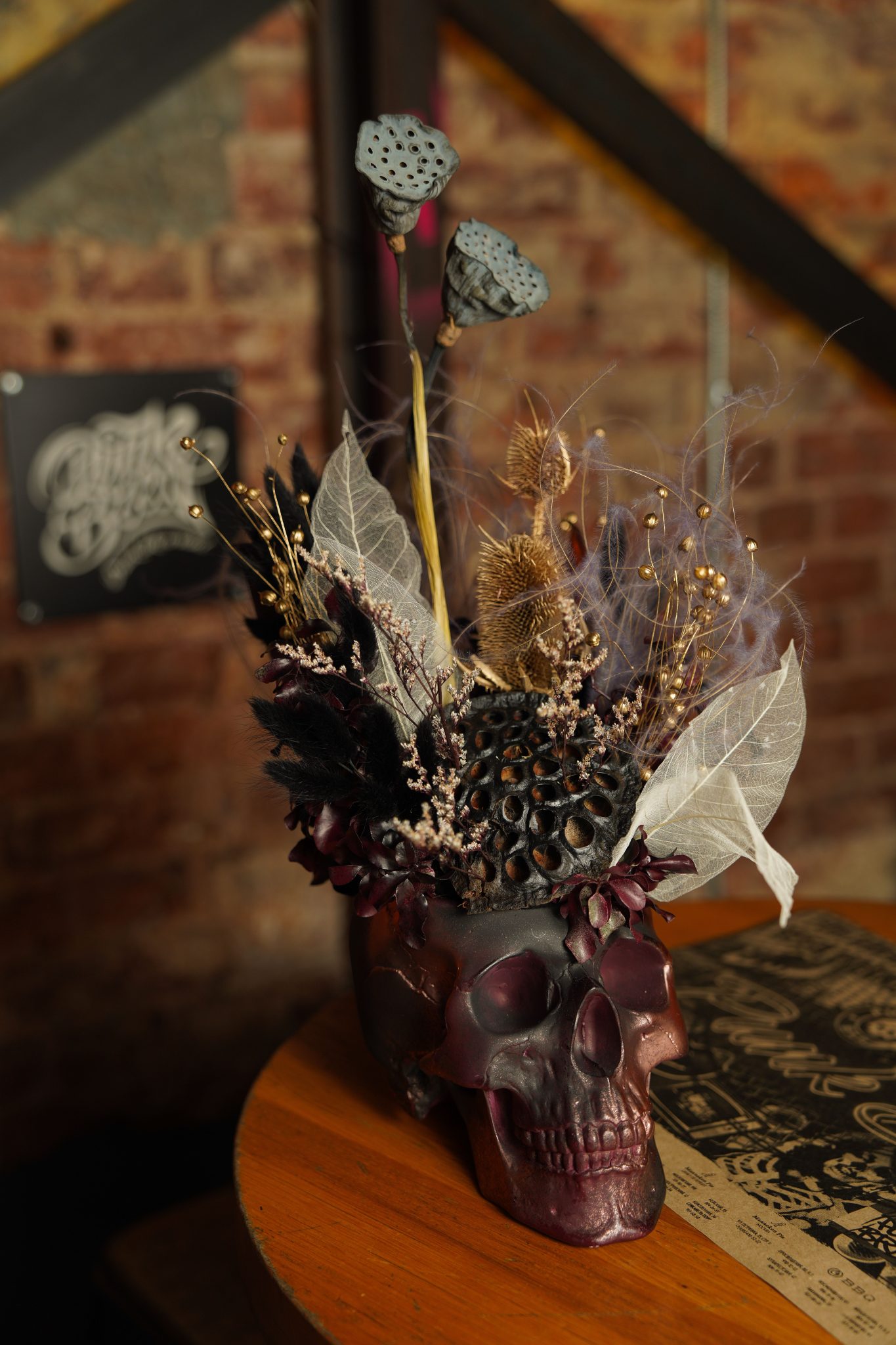 A dramatic skull arrangement with dried flowers and foliage, perfect for Halloween.