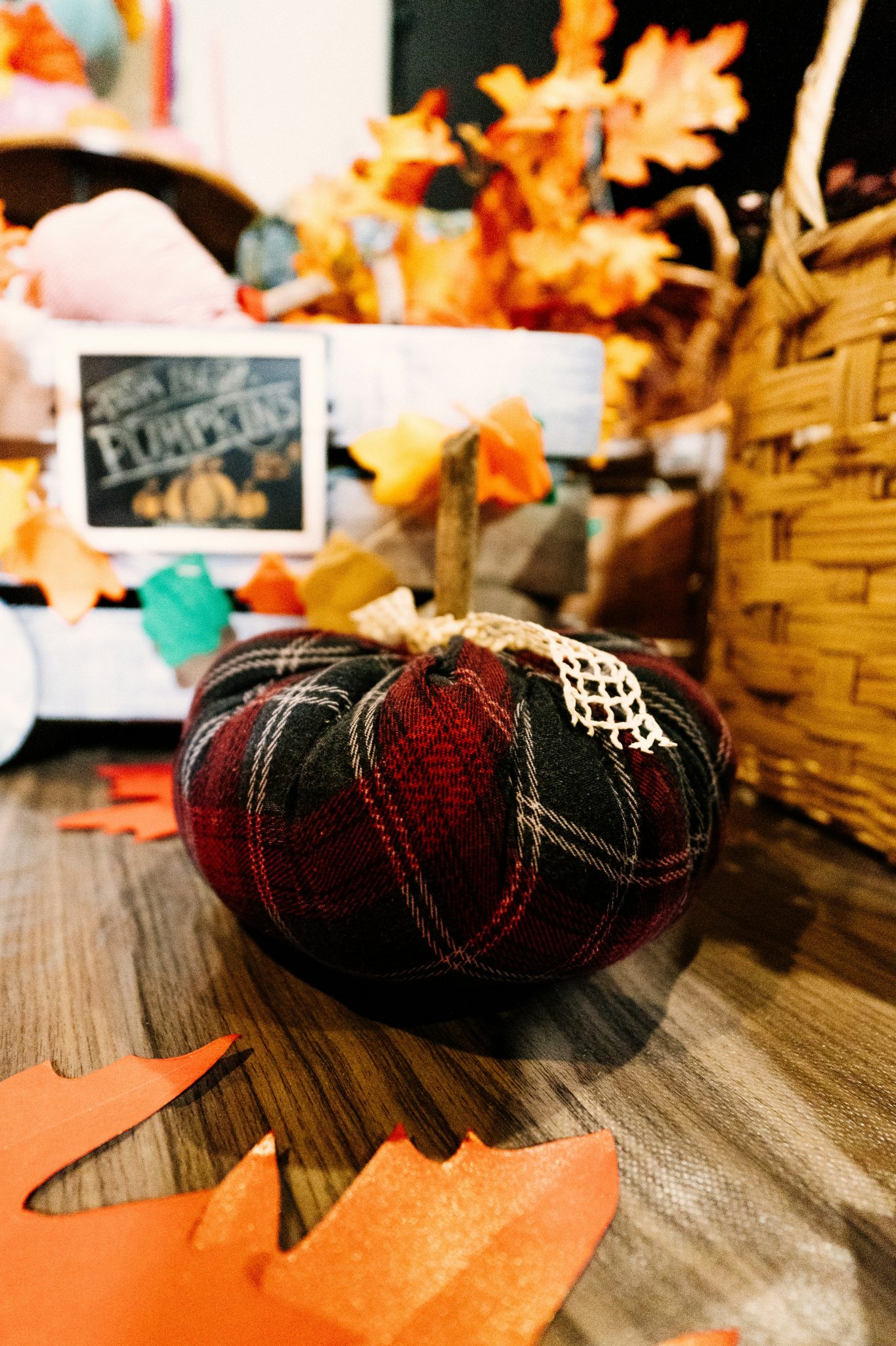 a plaid pumpkin sitting on a wooden table