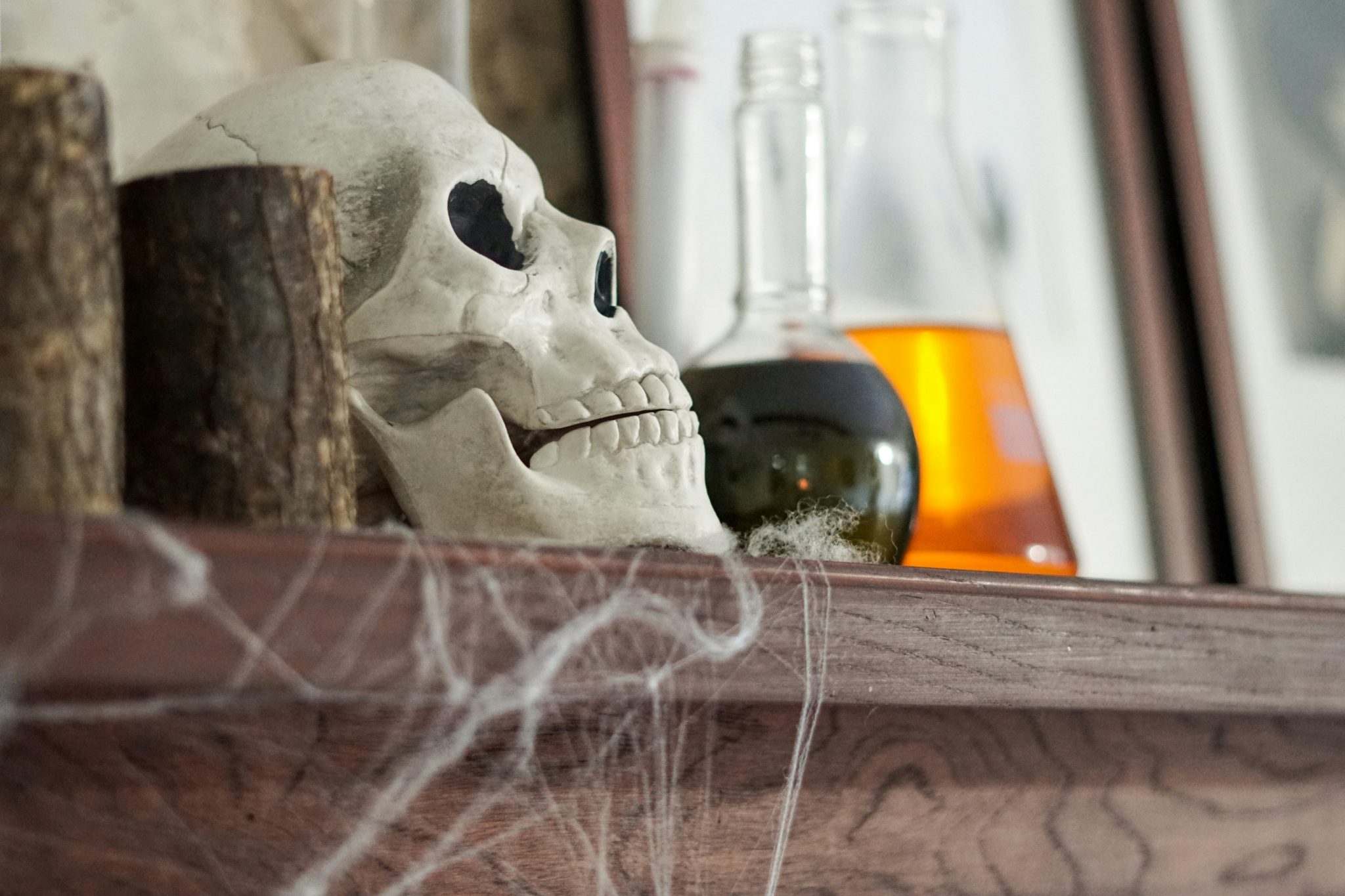 A skull on a shelf with potions