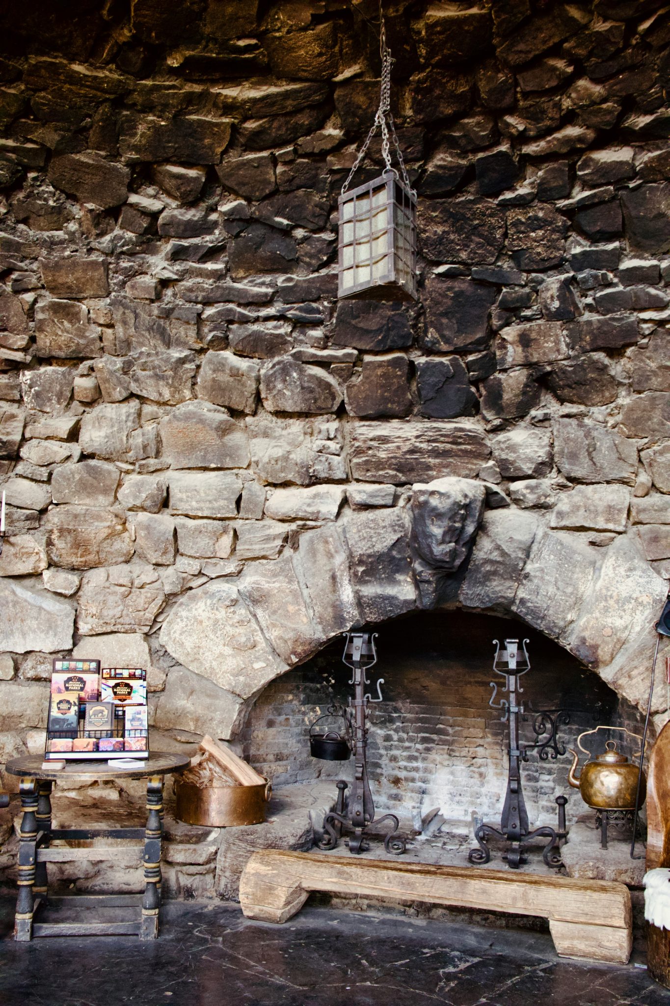 A stone fireplace in a stone walled room