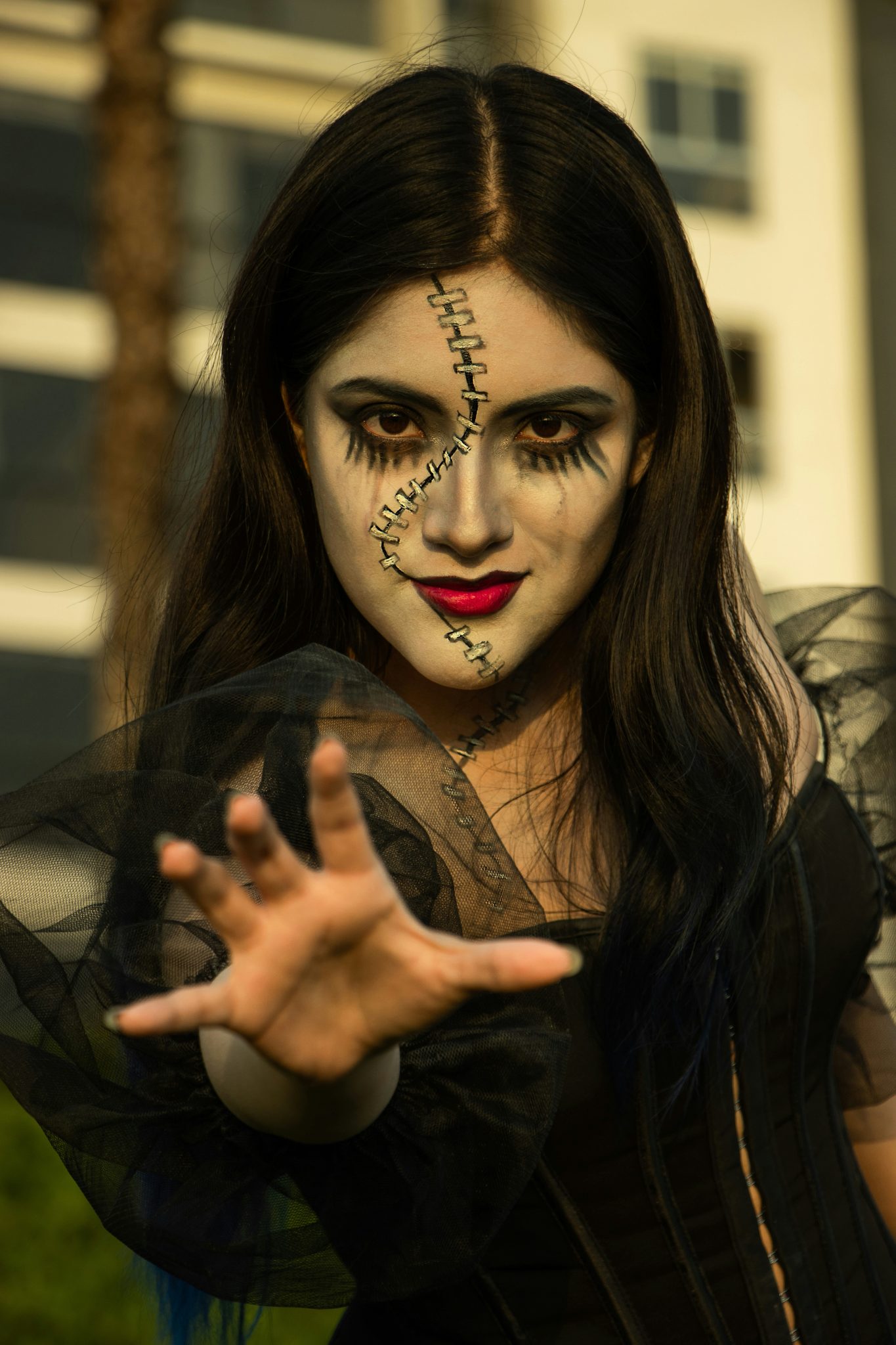 A woman dressed in a costume holding her hands out