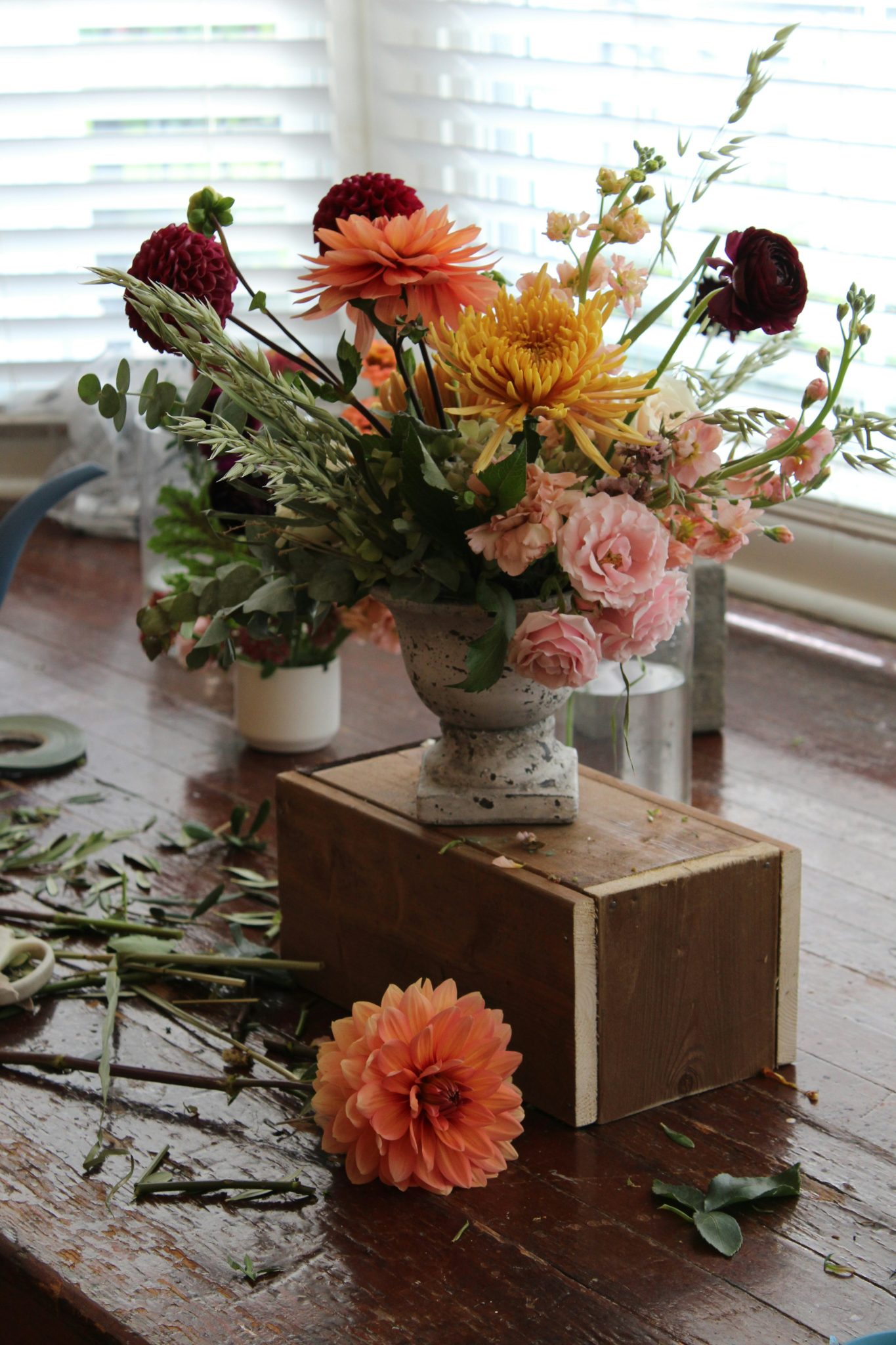 a wooden table topped with a vase filled with flowers