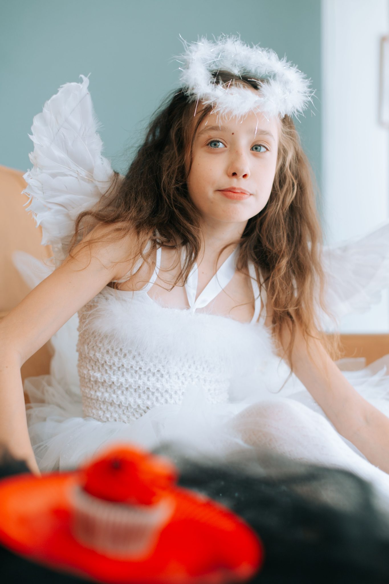 Charming child dressed as an angel with wings and halo, perfect for festive themes.